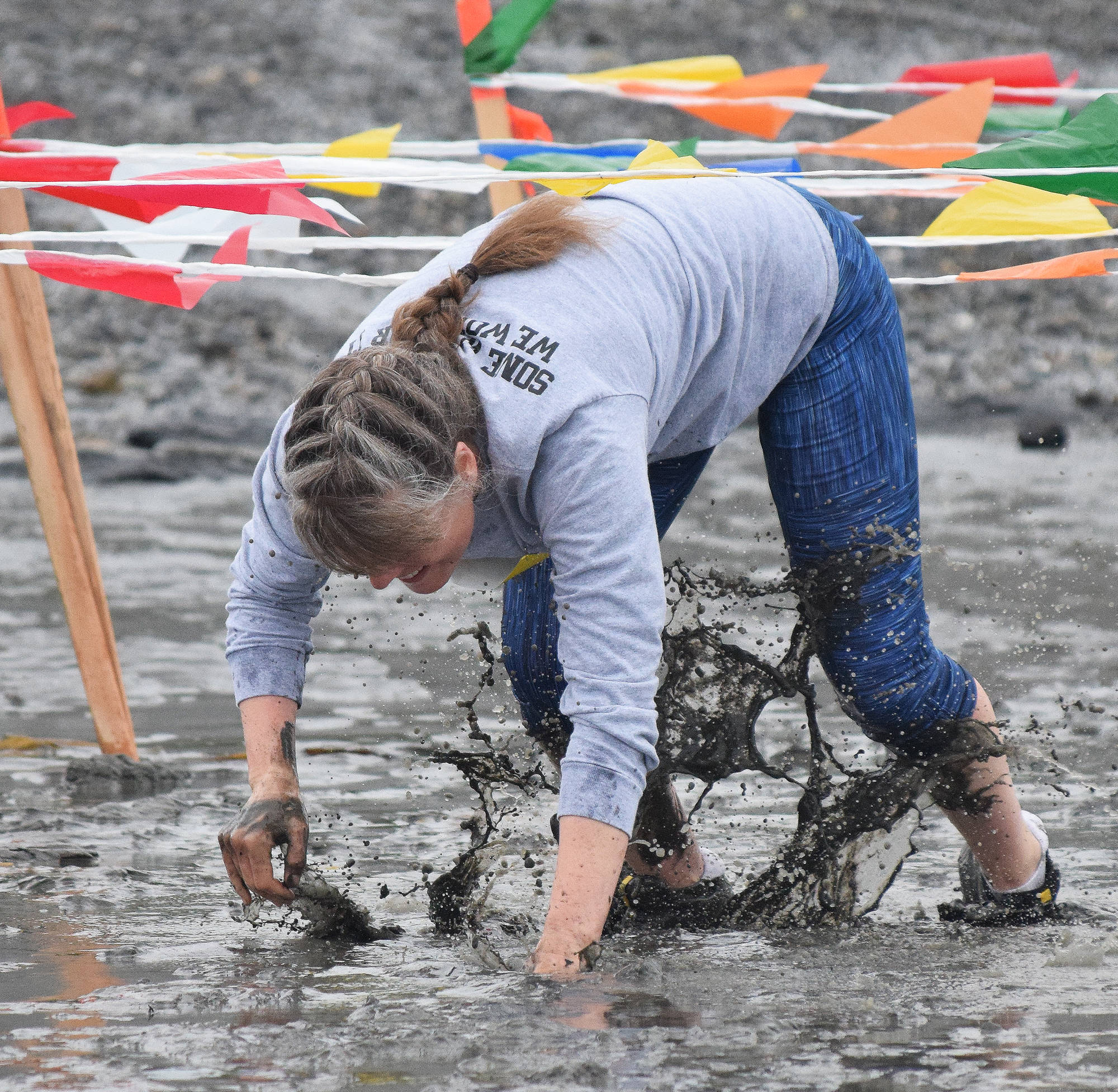 LaRae Bartolowits maneuvers through the mud crawl Saturday at the fourth annual Clam Scramble 5K in Ninilchik. (Photo by Joey Klecka/Peninsula Clarion)