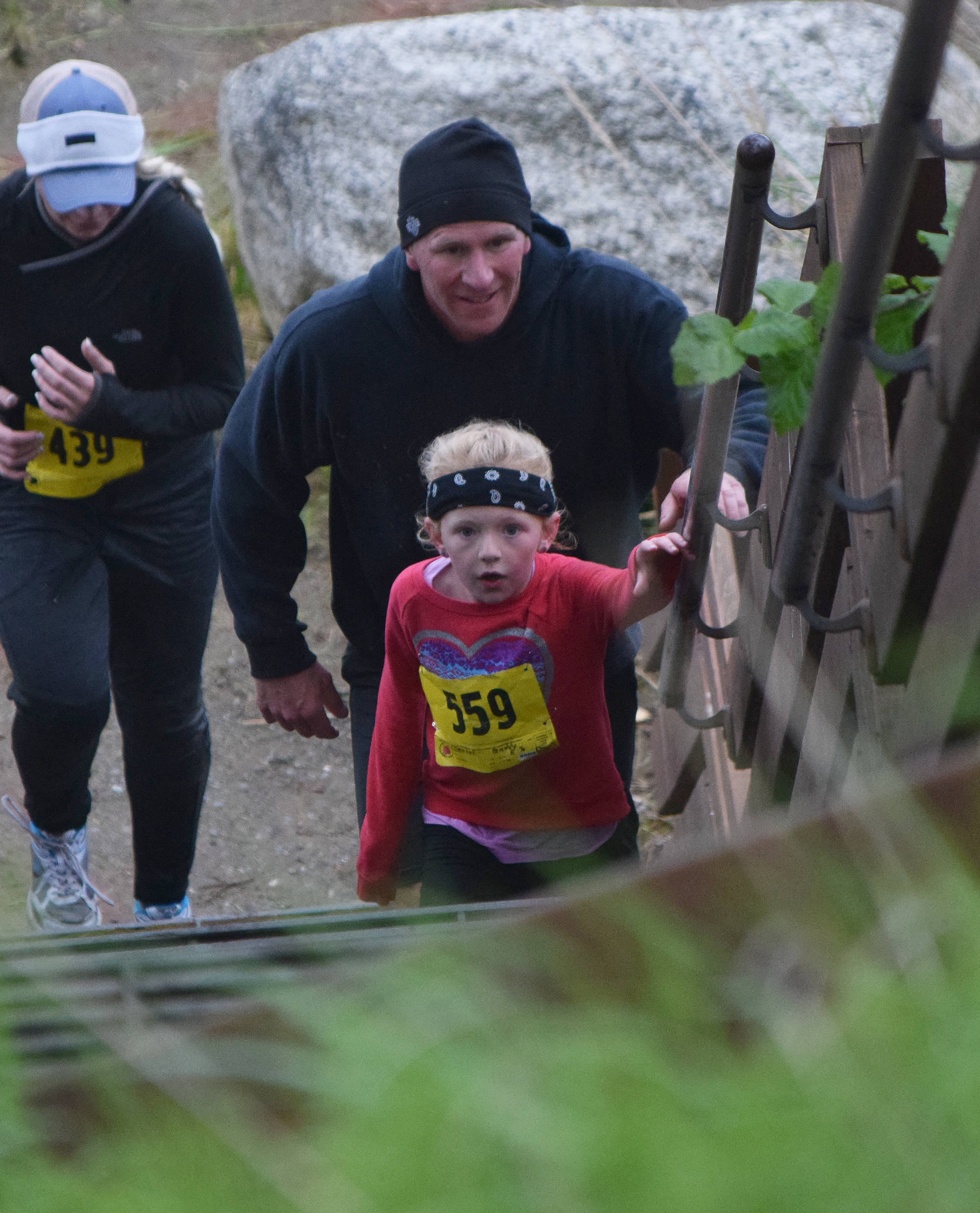Maddy (559) and John Campbell begin the final ascent up the stairs Saturday at the fourth annual Clam Scramble 5K in Ninilchik. (Photo by Joey Klecka/Peninsula Clarion)