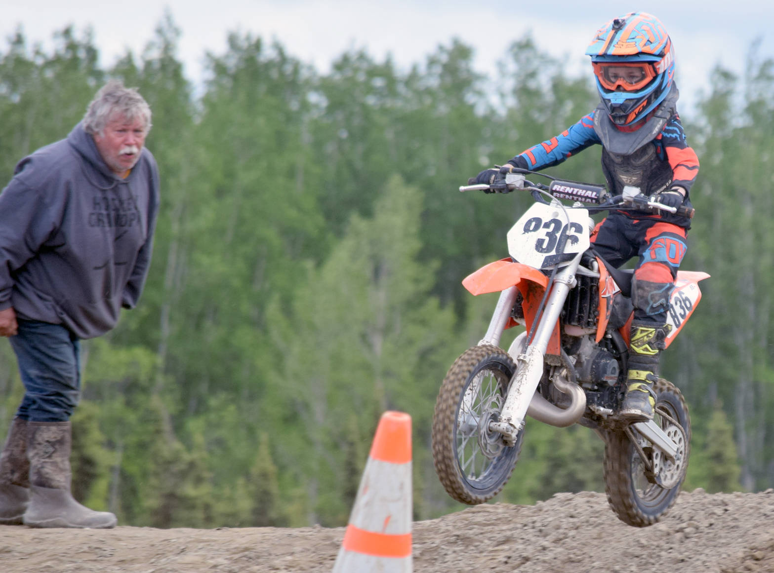 John Mullican, of Soldotna, cheers on his grandson, Draiden, in the 65cc Novice race at the Alaska State Motocross Championships at Twin City Raceway on Sunday, June 17, 2018.