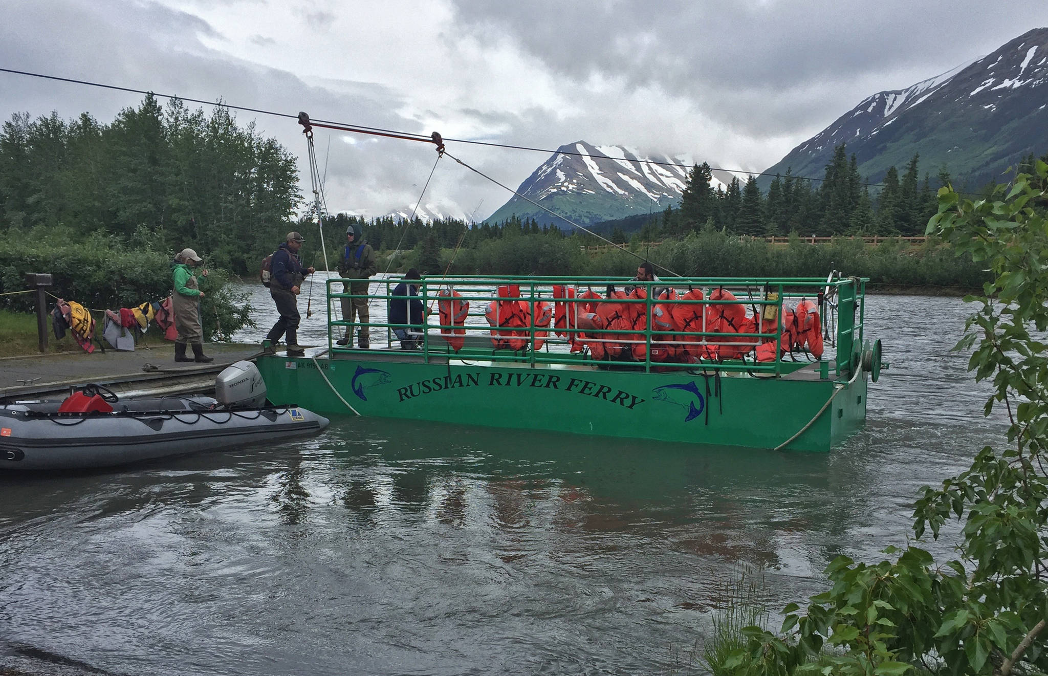 Anglers board the Russian River Ferry on the Kenai River just downstream of the confluence with the Russian River on Monday near Cooper Landing. (Photo by Elizabeth Earl/Peninsula Clarion)