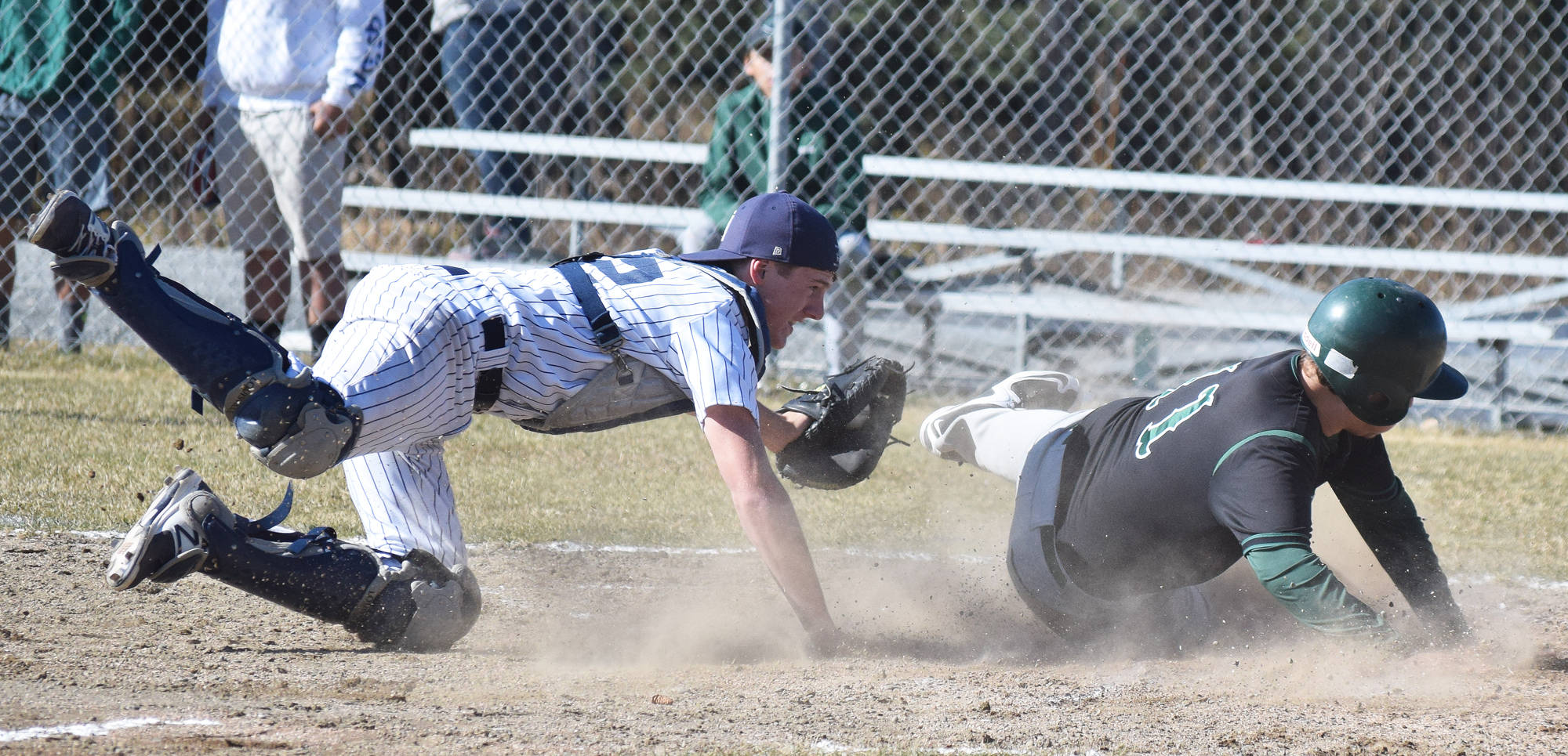 Soldotna catcher Cody Quelland (left) tags out Colony’s Zach Satterly in a Southcentral Conference contest May 9, 2017, at the Soldotna baseball fields. (Photo by Joey Klecka/Peninsula Clarion)