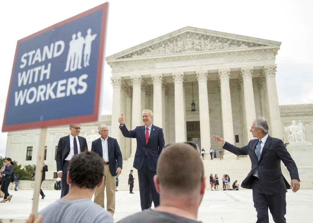 Illinois Gov. Bruce Rauner gives a thumbs up outside the Supreme Court, Wednesday, June 27, 2018 in Washington. From left are, Liberty Justice Center’s Director of Litigation Jacob Huebert, plaintiff Mark Janus, Rauner, and Liberty Justice Center founder and chairman John Tillman. The Supreme Court ruled Wednesday that government workers can’t be forced to contribute to labor unions that represent them in collective bargaining, dealing a serious financial blow to organized labor. (AP Photo | Andrew Harnik)