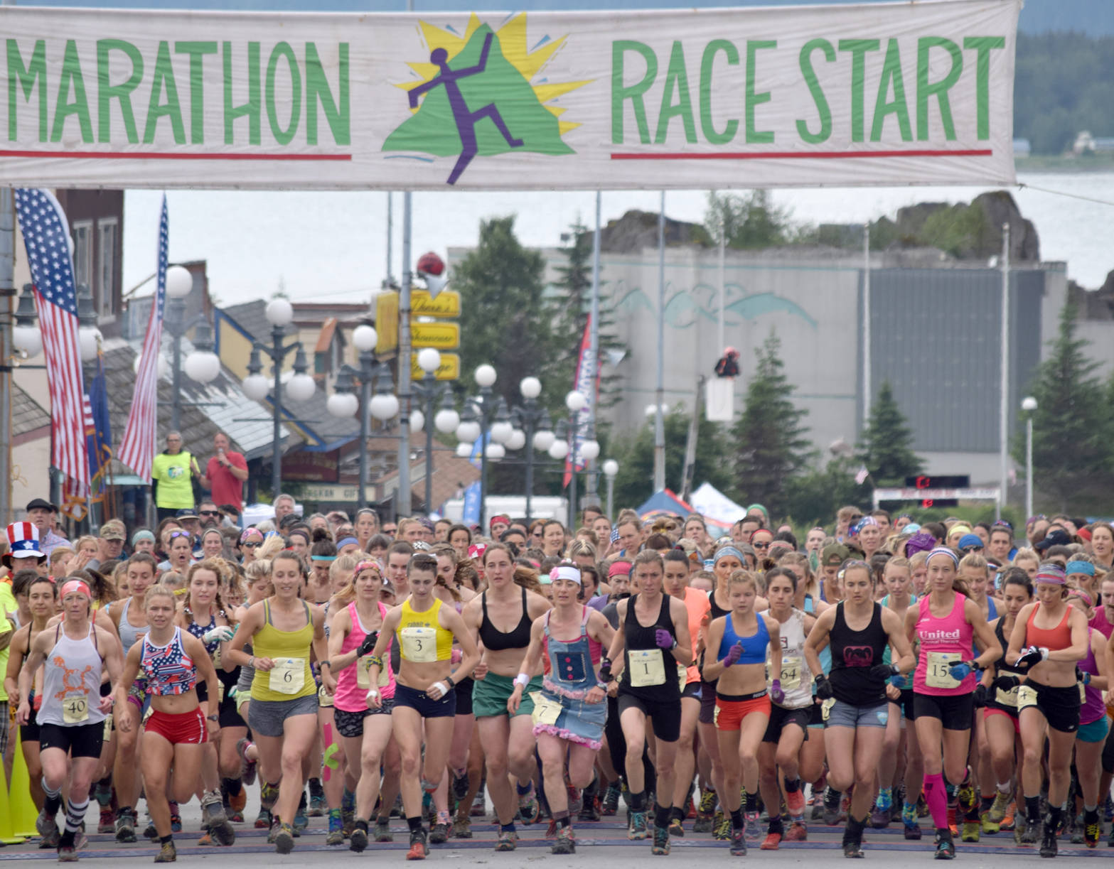 The women’s field takes to the course Tuesday, July 4, 2017, at Mount Marathon in Seward. Eventual winner Allie Ostrander is to the right of Christy Marvin (1). (Photo by Jeff Helminiak/Peninsula Clarion)