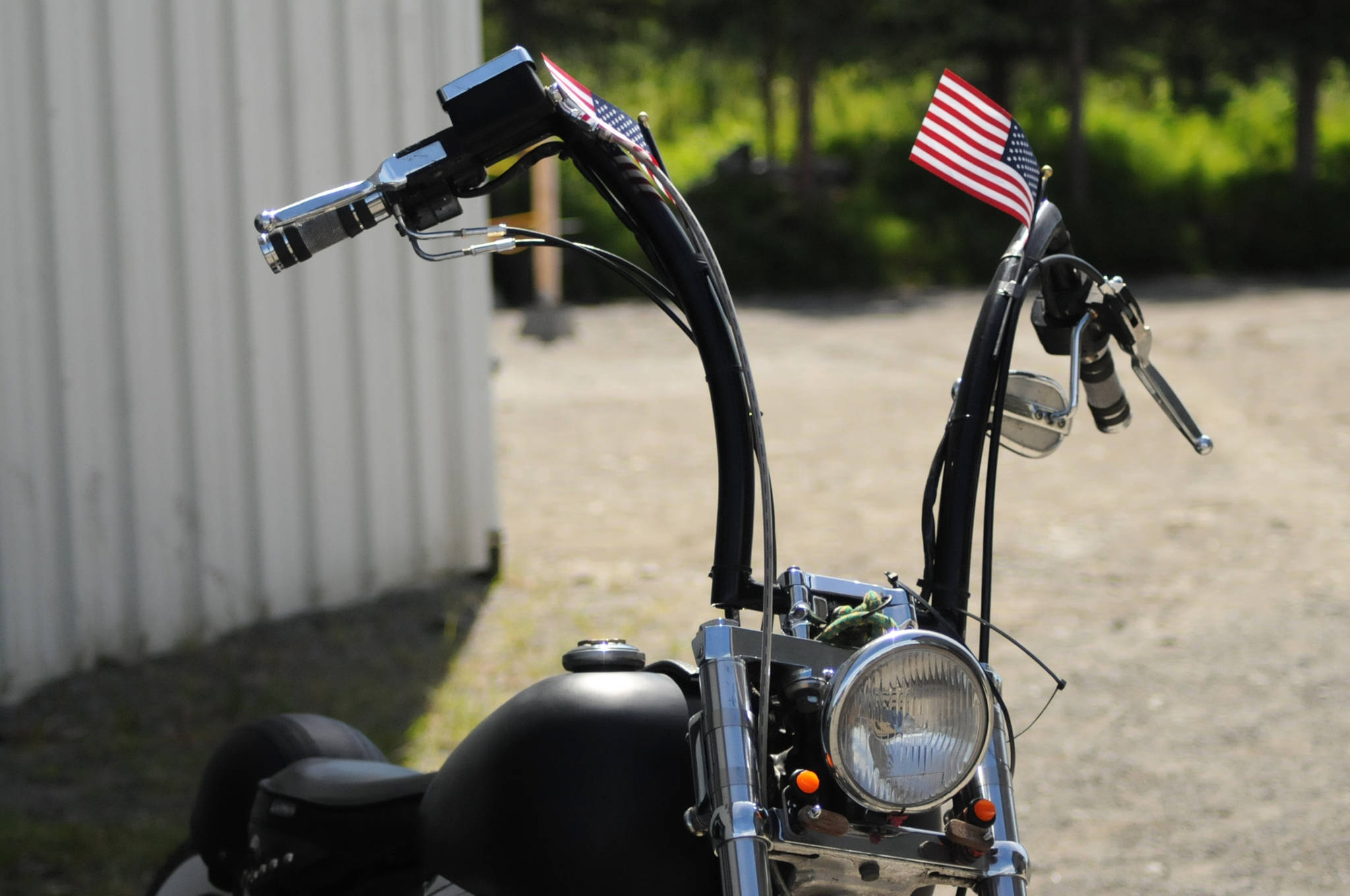 American flags decorate a motocycle outside the doors of the Peninsula Grace Brethren Church at a memorial service for Travis Stubblefield on Saturday, June 30, 2018 in Soldotna, Alaska. Stubblefield, a lifelong resident of the Soldotna area, was killed June 21 in a conflict in Kasilof. Alaska State Troopers are investigating the circumstances of his death, though no charges have yet been filed. (Photo by Elizabeth Earl/Peninsula Clarion)