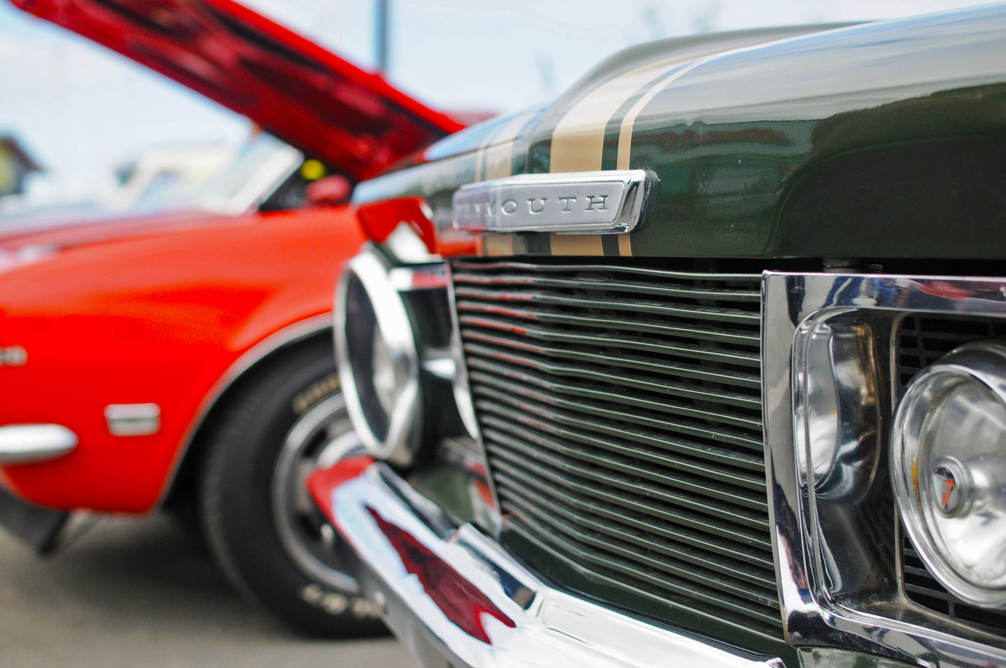 Darrell Aleckson’s restored Plymouth Barracuda, a classic 1960s car, sits in a parking lot alongside other restored classic cars at a Kaknu Kruzers’ car show at Autozone on Saturday, June 30, 2018 in Soldotna, Alaska. The Kaknu Kruzers, a local club composed of members who restore classic cars, will participate in a number of parades and shows this summer, including Soldotna’s Progress Days parade on July 28. (Photo by Elizabeth Earl/Peninsula Clarion)