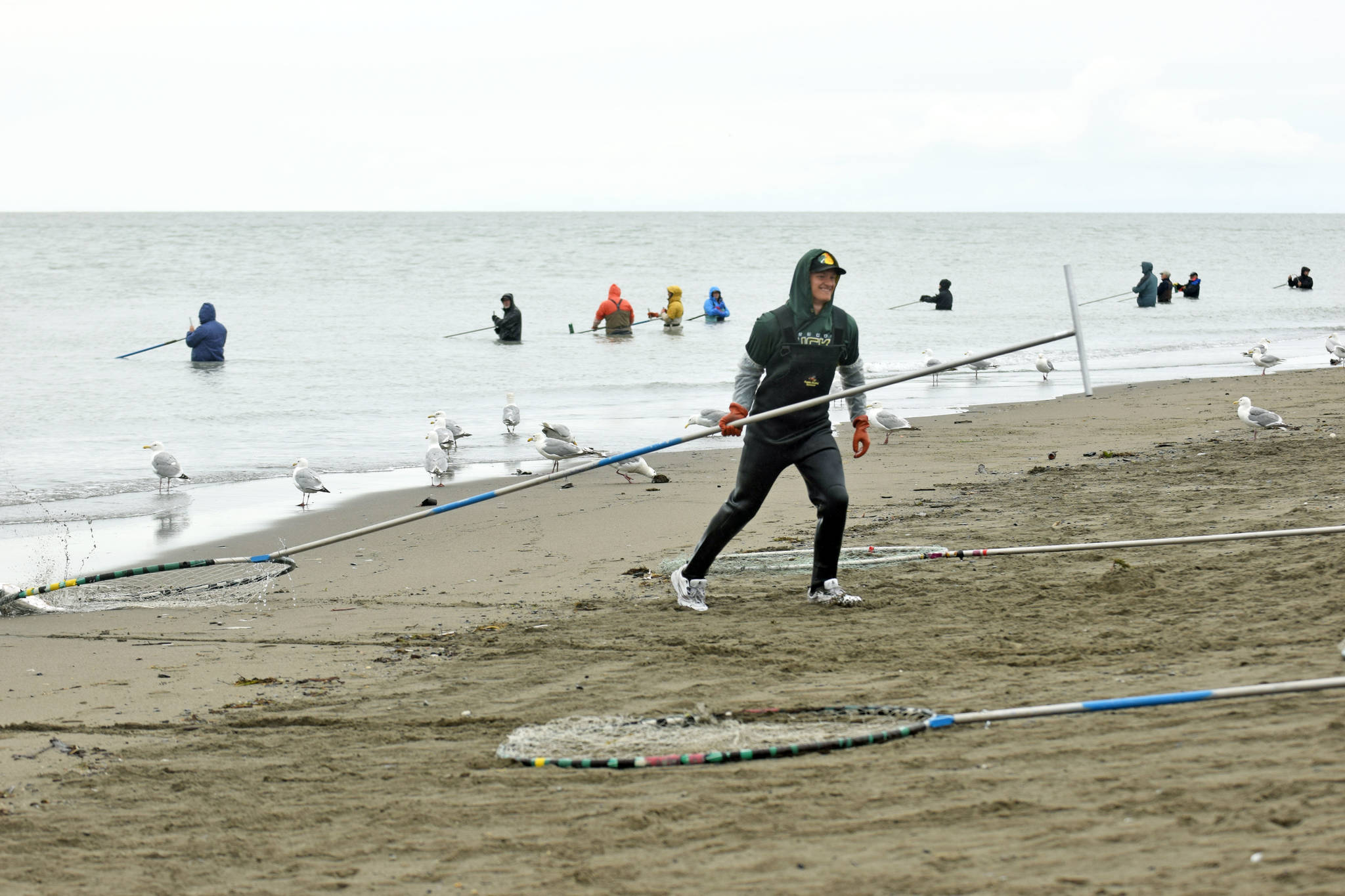 Anchorage resident Colton Herman drags his catch onto Kenai Beach during the opening day of dipnetting season on Tuesday, July 10, 2018, in Kenai, Alaska. Herman has come to Kenai to participate in dipnetting every year since he was a child. He said the catch had been slow so far, but would continue fishing until he got his quota. (Photo by Erin Thompson/Peninsula Clarion)
