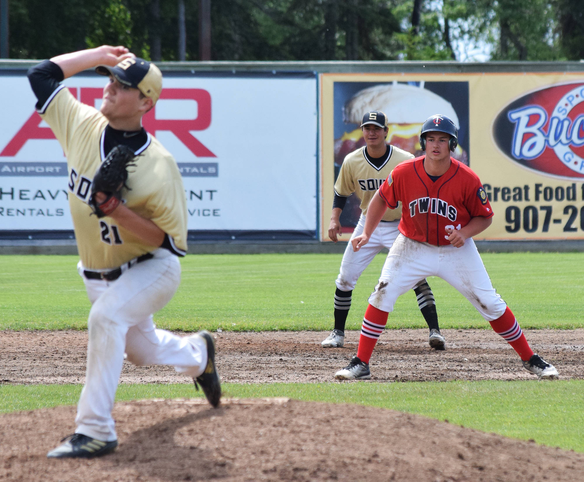 Legion Twins baserunner Andrew Carver (31) attempts a steal against South Anchorage pitcher Gunnar Nix, Wednesday afternoon at Coral Seymour Memorial Ballpark. (Photo by Joey Klecka/Peninsula Clarion)