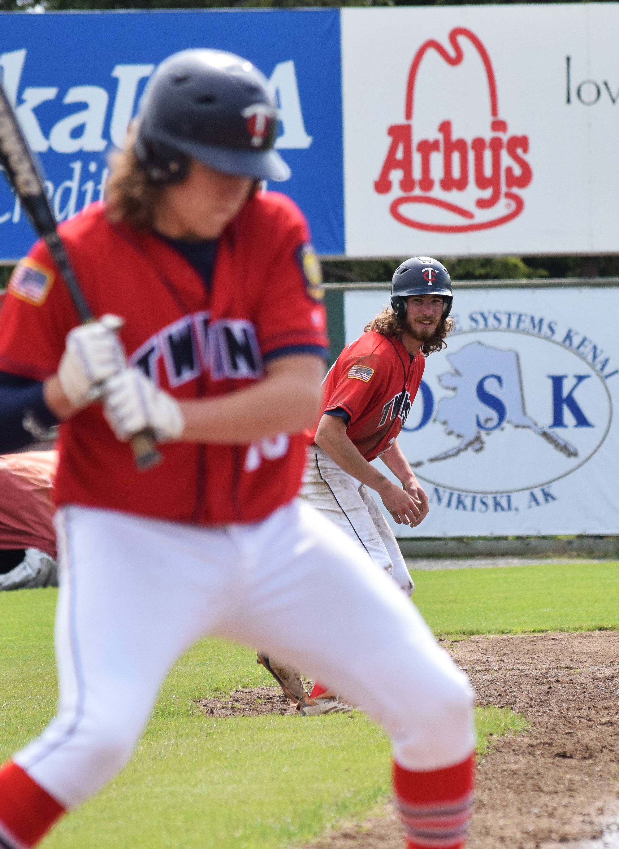 Legion Twins baserunner David Michael watches as teammate Logan Smith takes a pitch Wednesday afternoon from South Anchorage at Coral Seymour Memorial Ballpark. (Photo by Joey Klecka/Peninsula Clarion)