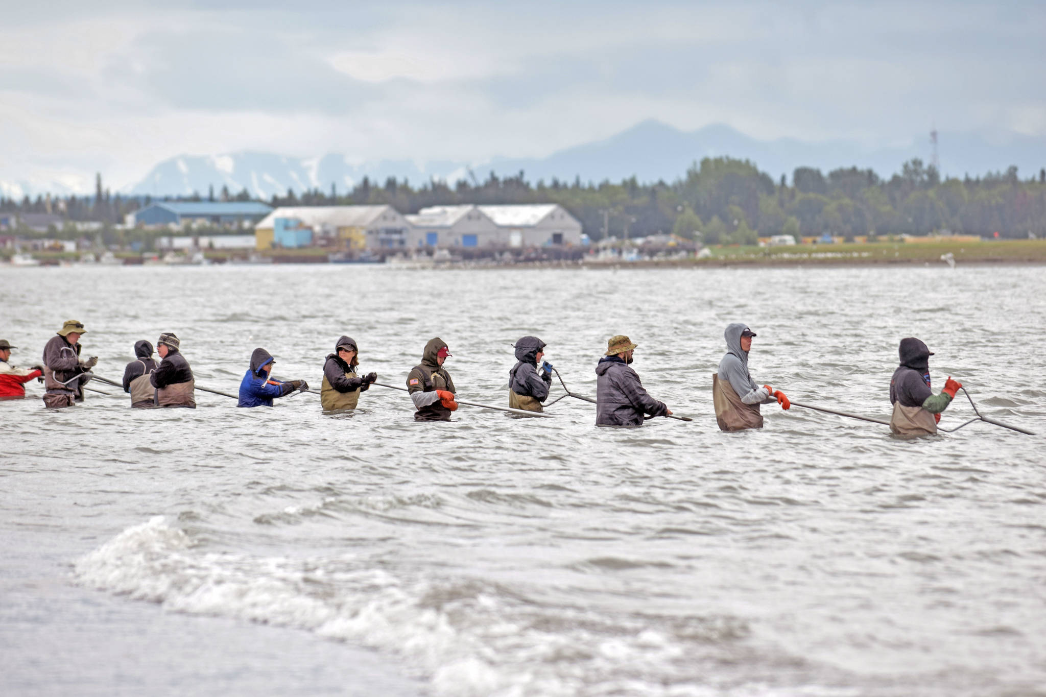 Dipnetters cast their nets along the shore of Kenai Beach on the opening day of the three-week dipnet season on Tuesday, July 10, in Kenai, Alaska. (Photo by Erin Thompson/Peninsula Clarion)