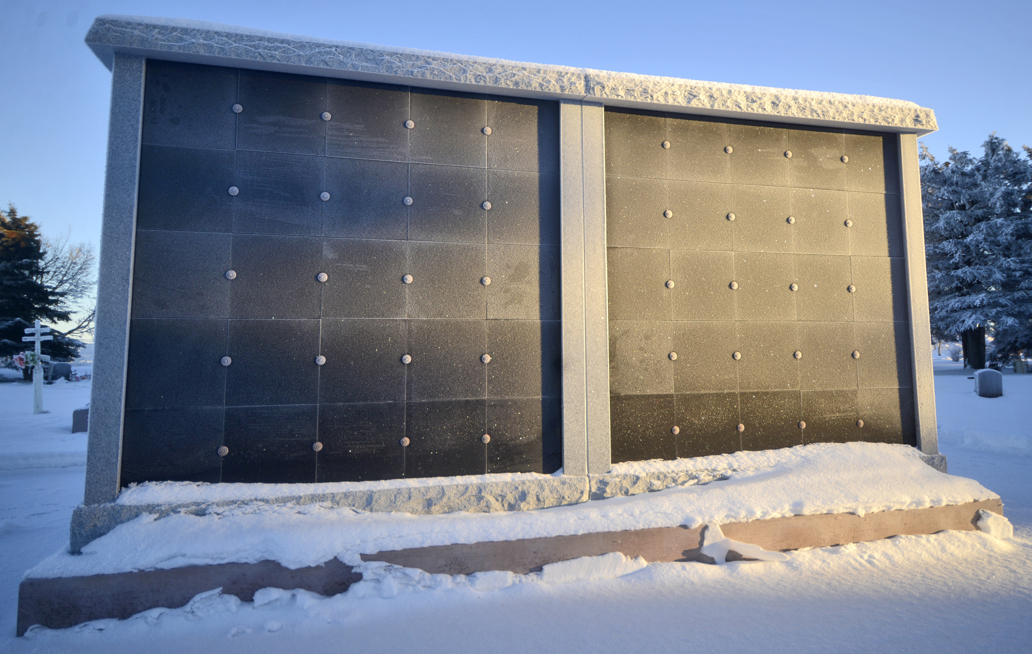 The blank grantite panels of a new 100-niche columbarium — a structure built to house cremated ashes — stand ready to be inscribed with names on Tuesday, Jan. 10 in the Kenai Cemetery. The columbarium’s construction finished in August 2015, and niches will be available after the Kenai city council sets a price. A tentative policy presented to the Kenai Parks and Recreation commission by Parks and Rec Director Bob Frates proposed $1000 for a columbarium niche. (Ben Boettger/Peninsula Clarion)