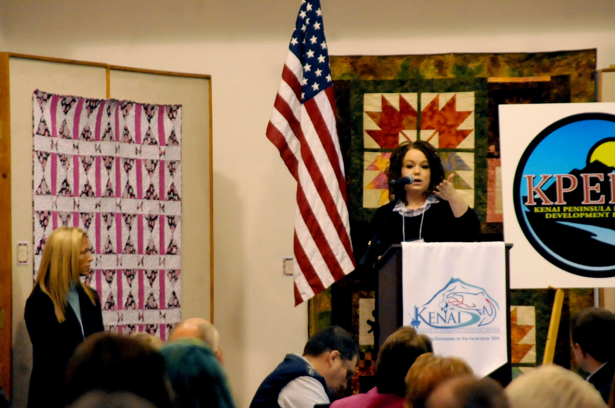 Shanon Davis (right), the executive director of the Kenai Peninsula Tourism Marketing Council, speaks to the crowd at the Industry Outlook Forum on Wednesday, Jan. 11, 2017 at the Kenai Visitors and Cultural Center in Kenai, Alaska. The annual forum, hosted by the Kenai Peninsula Economic Development District, features speakers from a variety of different industries to provide insight on the upcoming year in their businesses. (Elizabeth Earl/Peninsula Clarion)