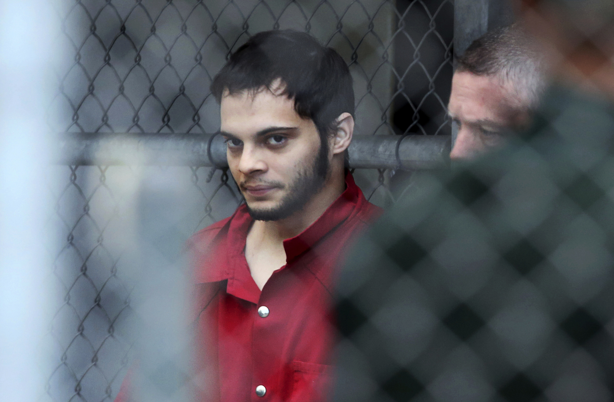 Esteban Santiago is taken from the Broward County main jail as he is transported to the federal courthouse in Fort Lauderdale, Fla., on Monday, Jan. 9, 2017. Santiago is accused of fatally shooting several people at a crowded Florida airport baggage claim and faces airport violence and firearms charges that could mean the death penalty if he's convicted. (Amy Beth Bennett/South Florida Sun-Sentinel via AP)