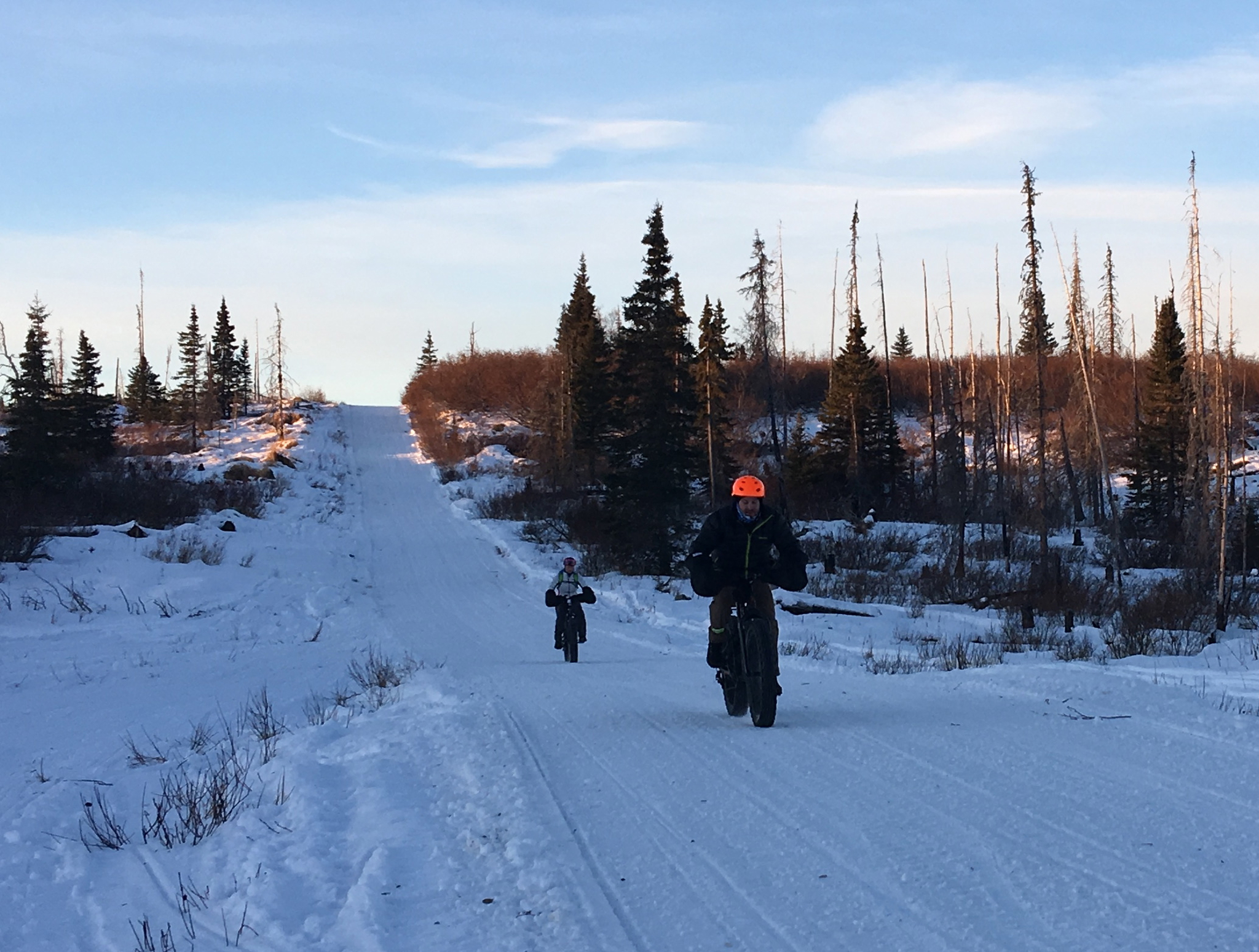 Sean Dunham and Morgan Aldridge pedal fat-tire bikes in the Caribou Hills near Ninilchik on Jan. 8, 2017. (Photo by Will Morrow/Peninsula Clarion)