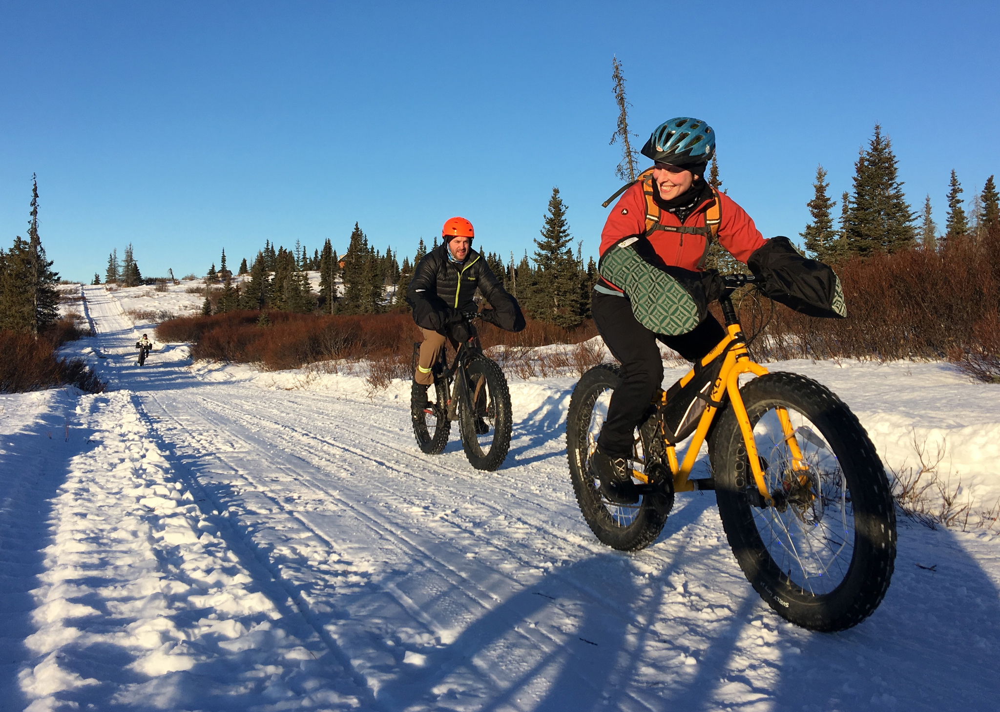 Angie Brennan and Sean Dunham pedal fat-tire bikes in the Caribou Hills near Ninilchik on Jan. 8, 2017. (Photo by Will Morrow/Peninsula Clarion)
