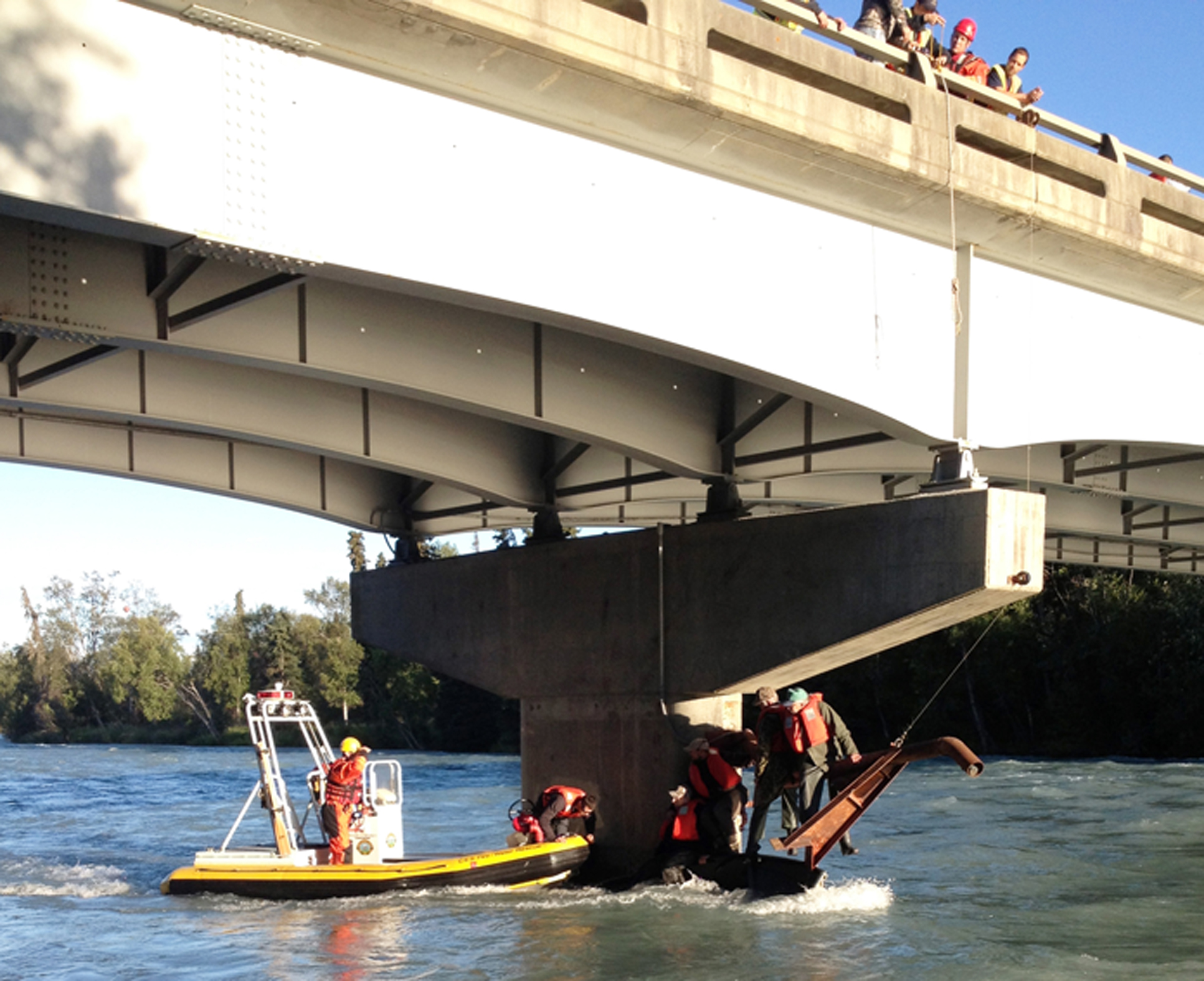 Responders rescue four men from the Kasilof River after a current overturned their boat shortly after they launched into the river Monday morning under the Kasilof Bridge of the Sterling Highway.