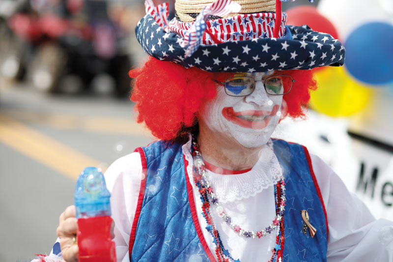 A clown entertains the crowd during Kenai's annual Fourth of July parade.