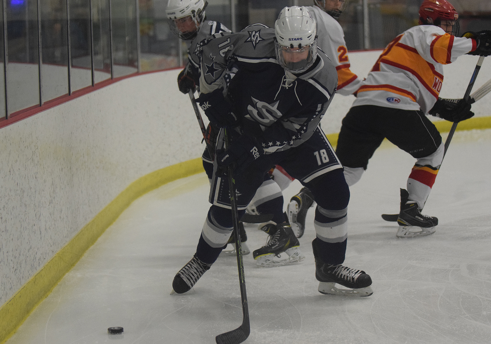 Soldotna sophomore Cameron Knowlton collects the puck behind the SoHi net in Friday's 4A state hockey tournament at the Curtis Menard Sports Complex in Wasilla. West Valley beat SoHi 7-1.