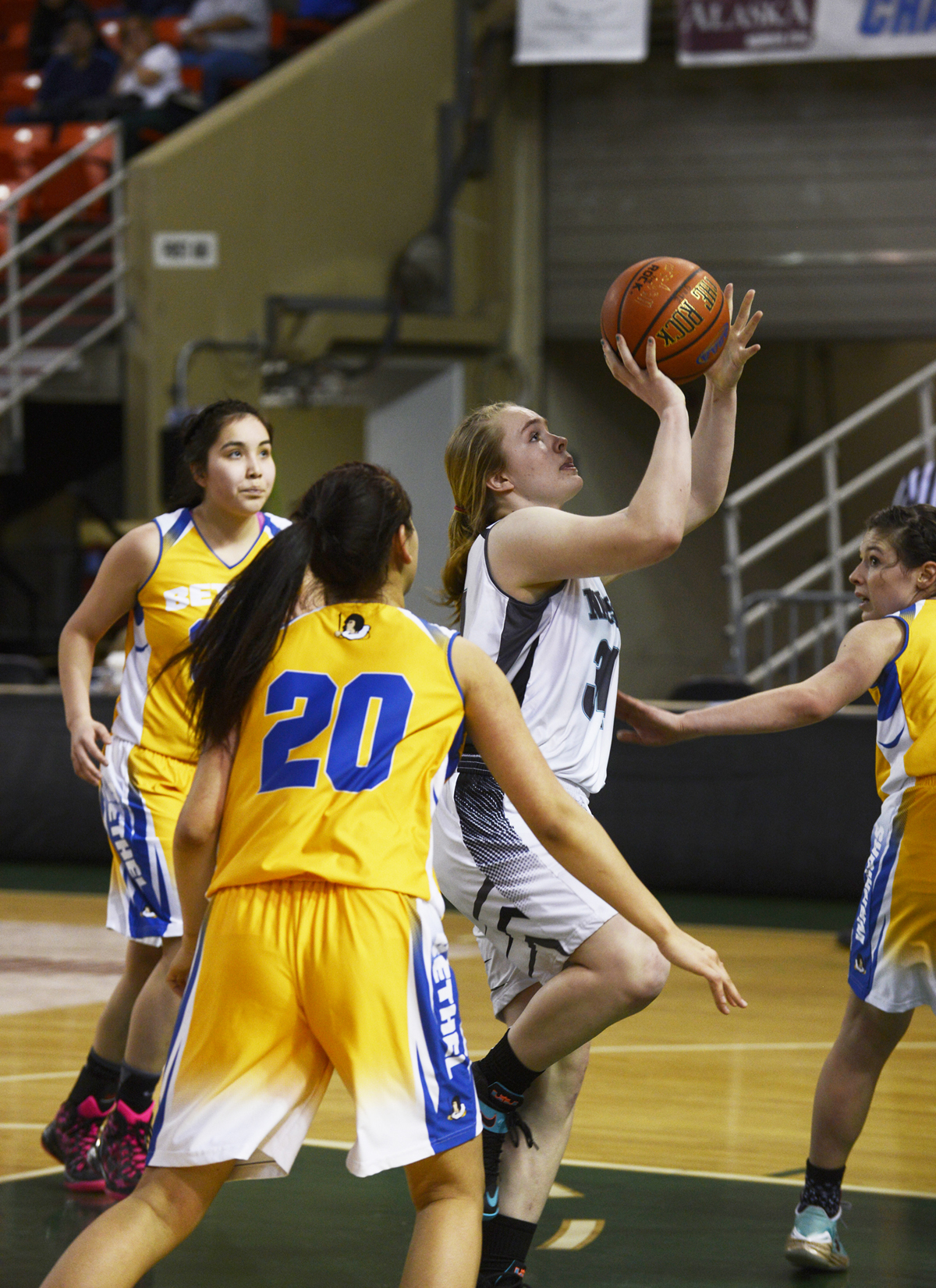 Nikiski senior Chena Litzen drives the lane for a layup midway through the third quarter Friday against Bethel at the Sullivan Arena. The Bulldogs won 37-22 to advance to Saturday's fourth-place game against ACS.