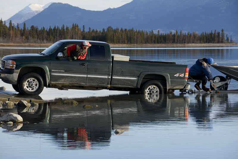 Two men haul a boat out of Skilak Lake near the end of the 2014 fishing season.