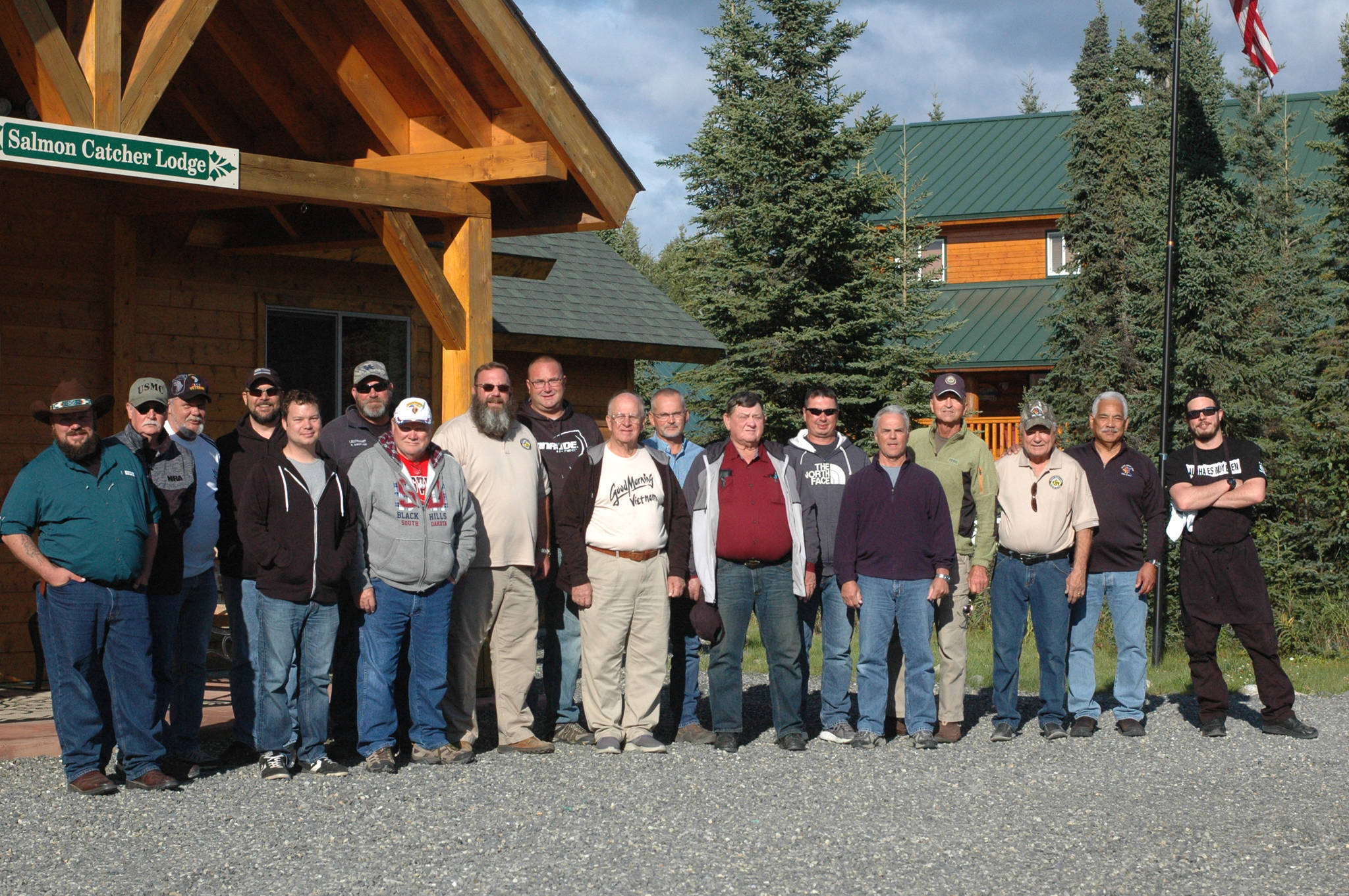 A group of veterans visiting Alaska as part of the Kentucky Wounded Heroes project gather in front of the Salmon Catcher Lodge on Friday, Aug. 31, 2018 in Soldotna, Alaska. (Photo by Elizabeth Earl/Peninsula Clarion)