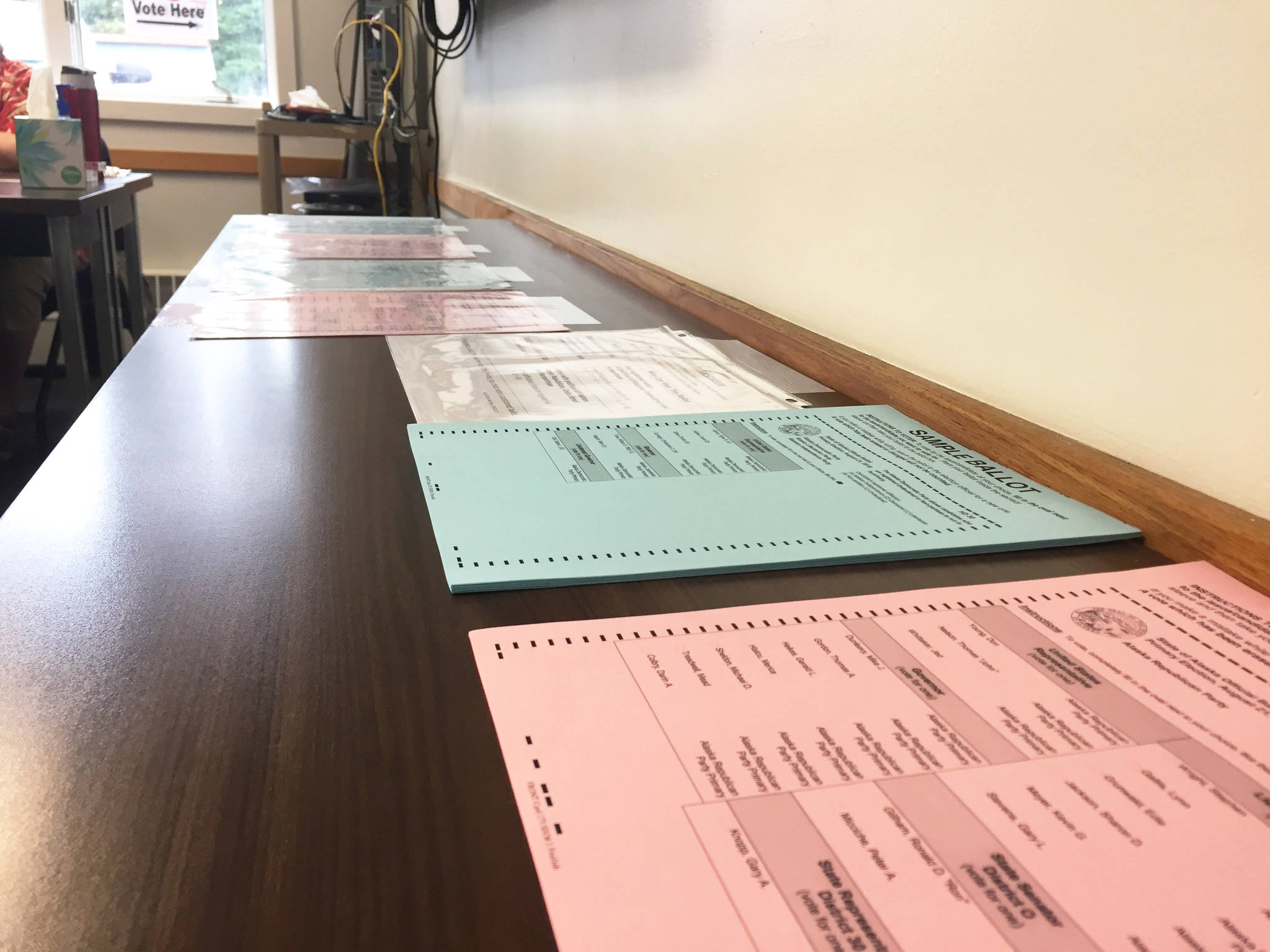 Sample ballots sit on a tabletop at the the Kalifornsky Beach Road Central Emergency Services fire station on Tuesday, Aug. 21, 2018 near Kenai, Alaska. (Photo by Elizabeth Earl/Peninsula Clarion)