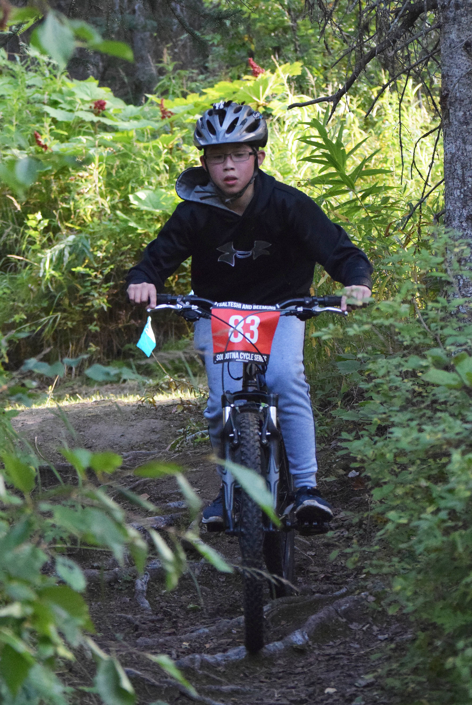 Youth rider Sean Raften navigates a rooted section of trail in the Soldotna Cycle Series season finale held Aug. 30, 2018, at the Tsalteshi Trails. (Photo by Joey Klecka/Peninsula Clarion)