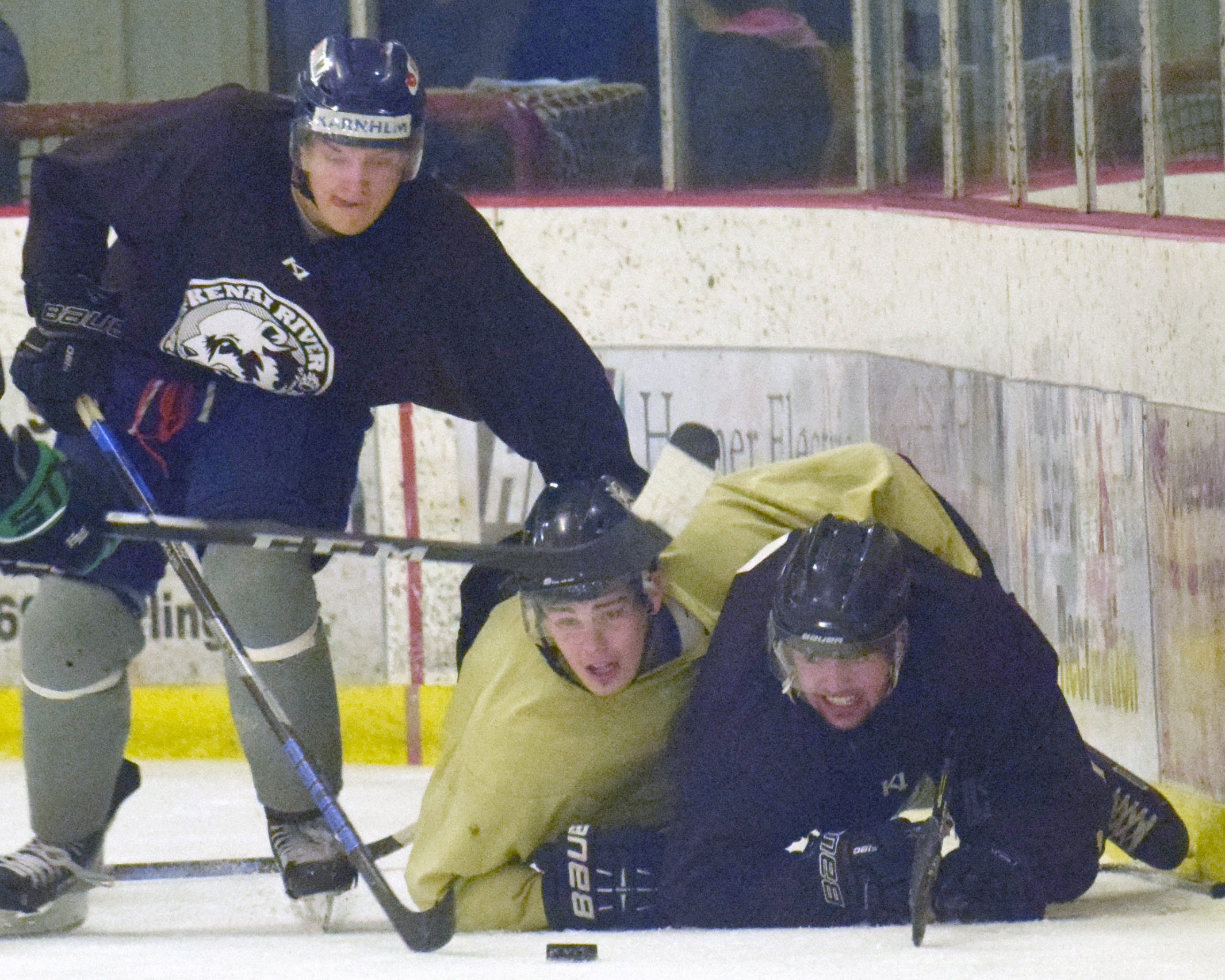 Filip Karlsson of the Brown, Preston Weeks of the Gold and Emils Ezitis of the Brown battle for the puck Friday, Sept. 7, 2018, in the Brown-Gold Game at the Kenai Multi-Purpose Facility. (Photo by Jeff Helminiak/Peninsula Clarion)