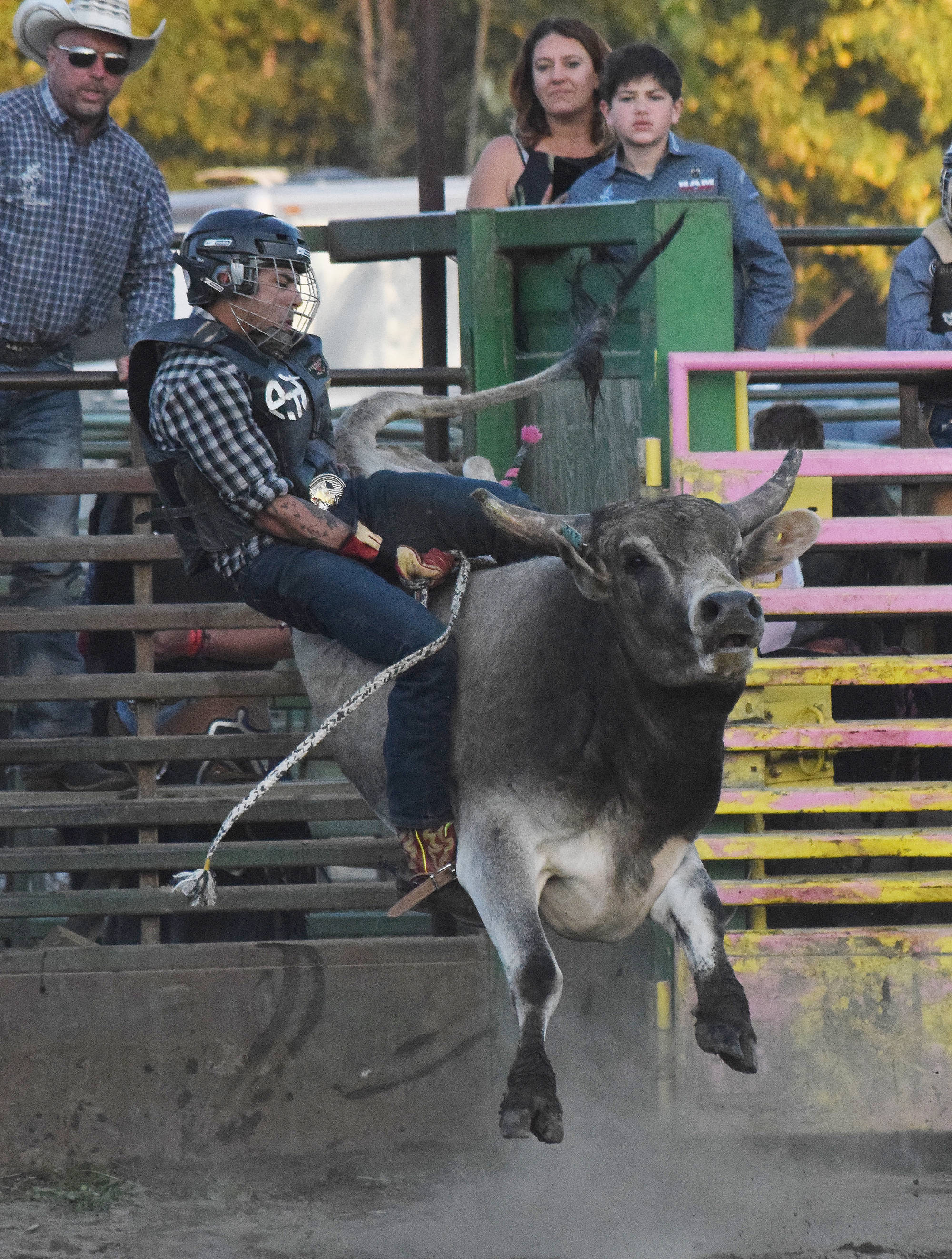 A youth rider attempts to ride out a bucking bull Saturday at the 9/11 Tribute Rodeo at the Soldotna Rodeo Grounds. (Photo by Joey Klecka/Peninsula Clarion)