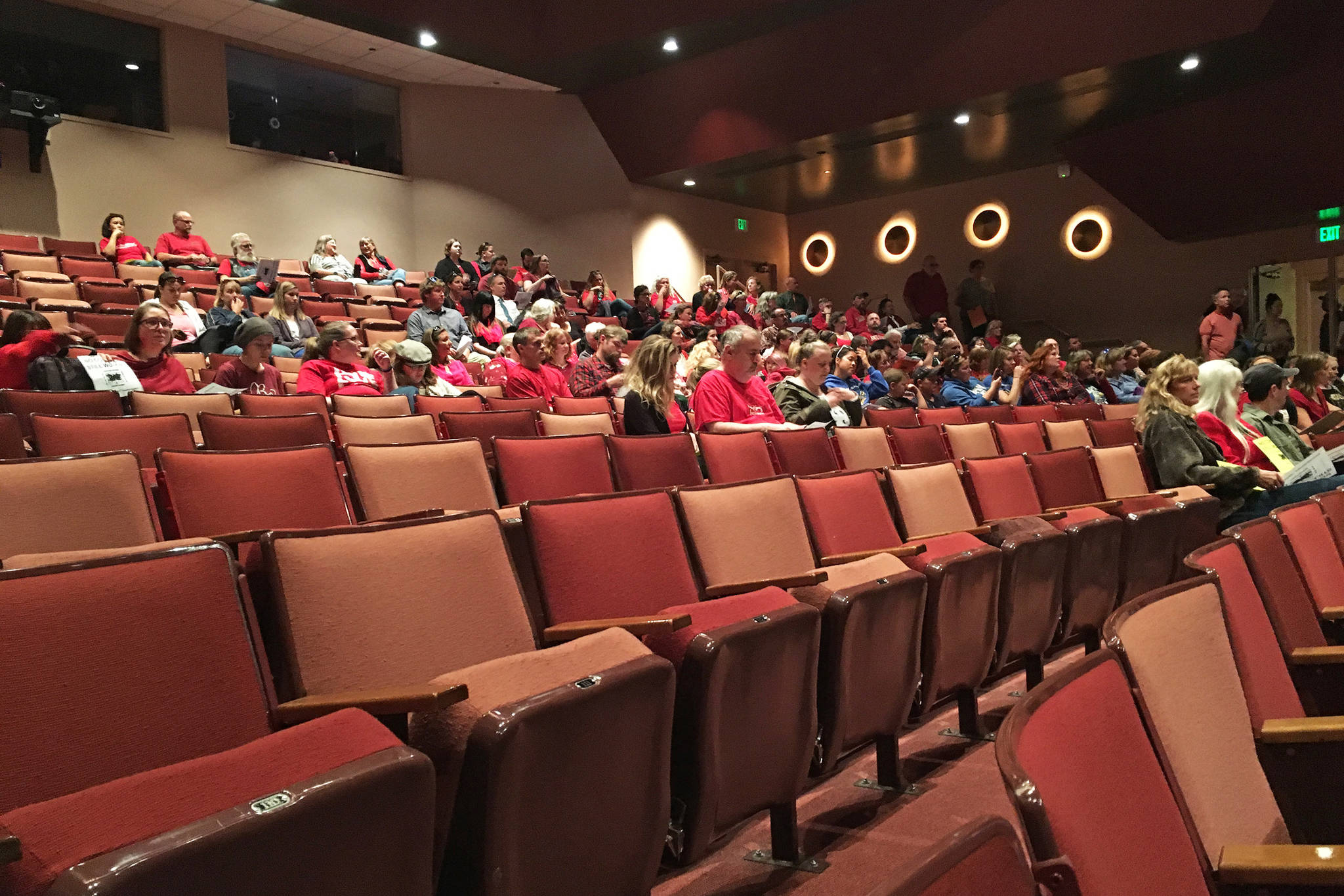 Teachers, support staff and community members, many of them wearing red, prepare to listen to the Kenai Peninsula Borough School District Board of Education’s Monday, Sept. 10, 2018 meeting at Homer High School in Homer, Alaska. The board holds one meeting each year in Homer, and another in Seward. (Photo by Megan Pacer/Homer News)