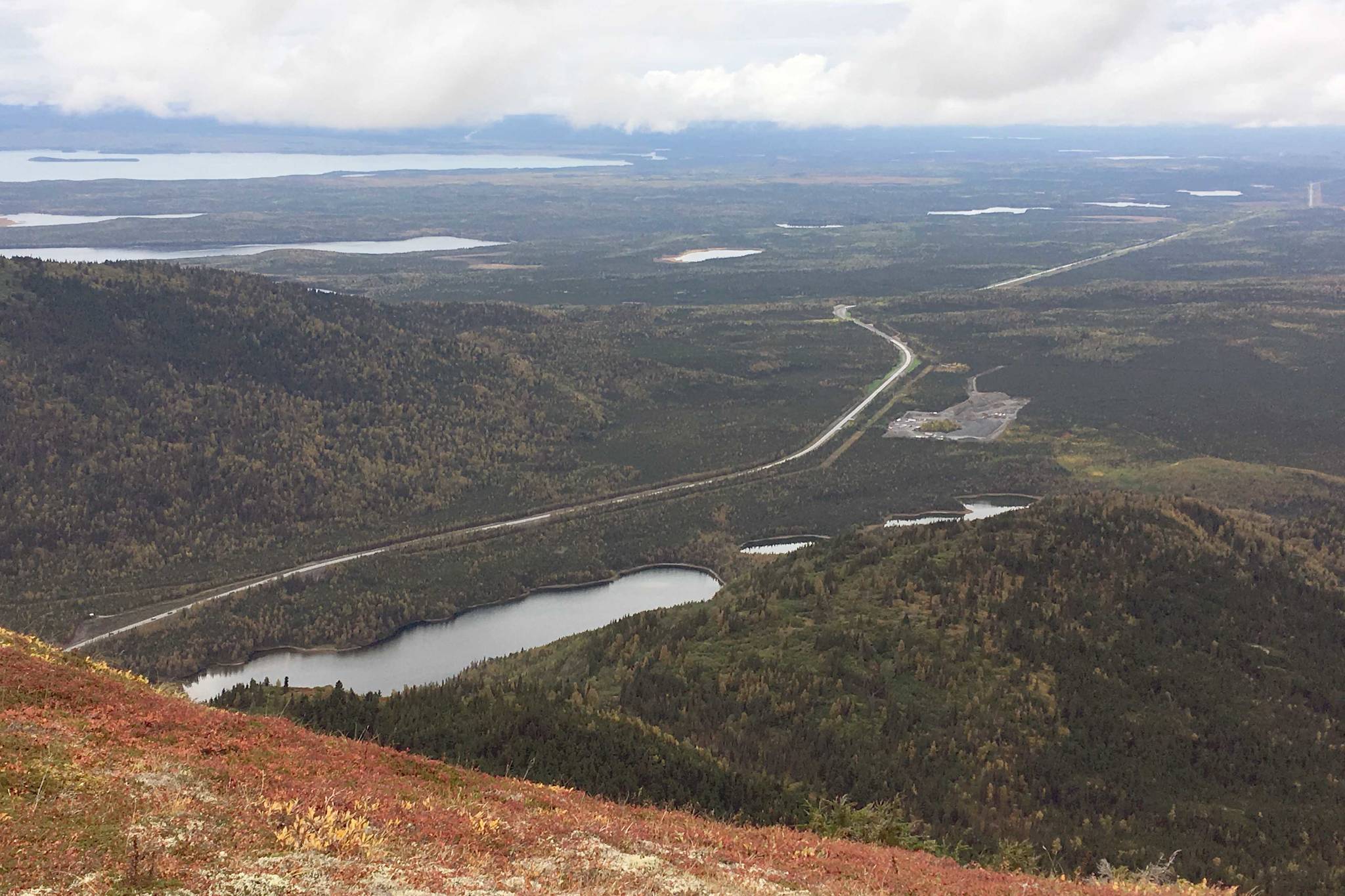 The autumn tones of the Mystery Hills sit above the Sterling Highway on Sunday, Sept. 16, 2018, on an overcast day. The forecast calls for similar cloudy conditions, with highs in the upper 50s and lows in the lower 40s, throughout the rest of the week as autumn colors reach their peak. (Photo by Jeff Helminiak/Peninsula Clarion)