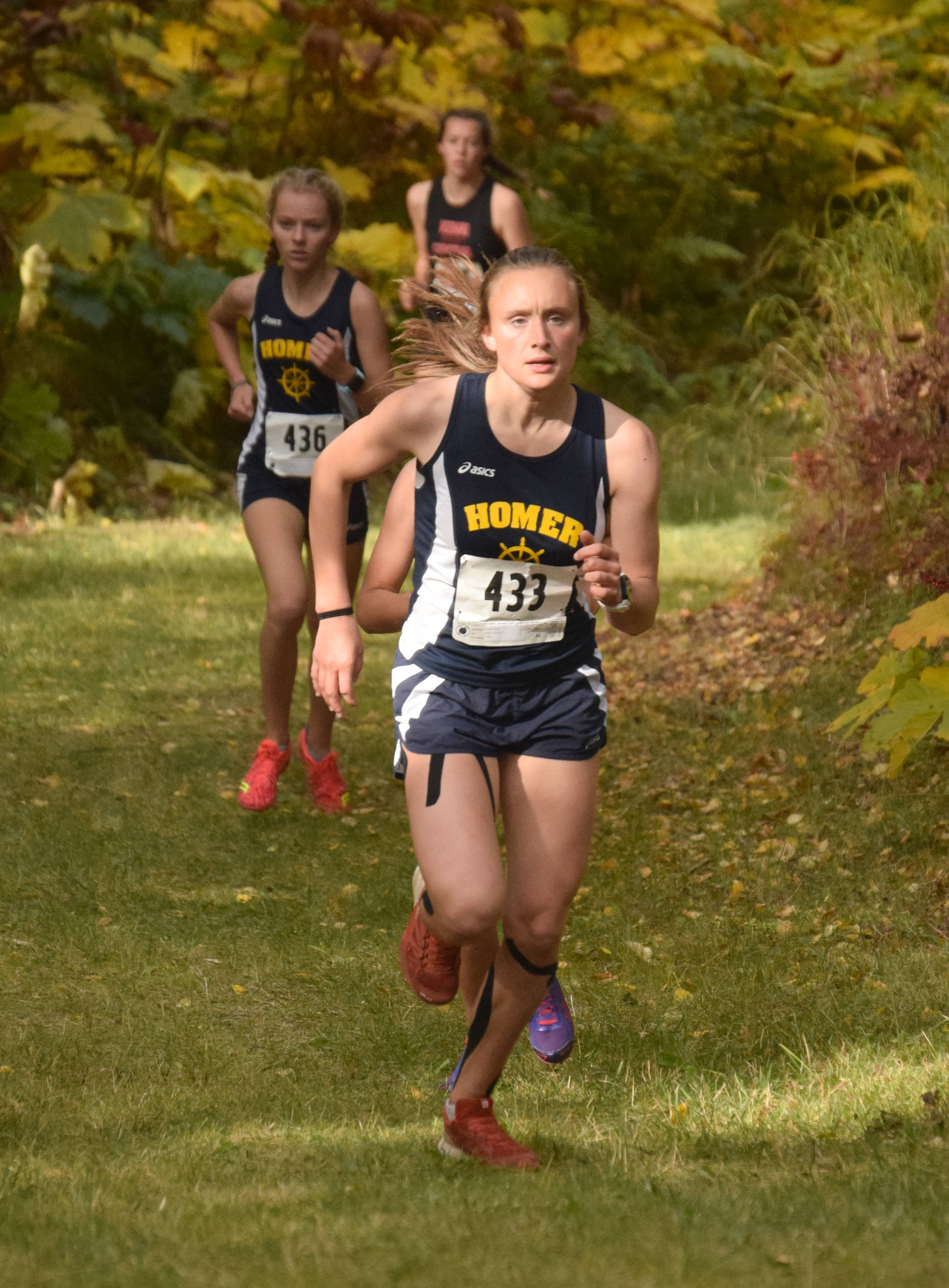 Homer’s Autumn Daigle powers up a hill at the Kenai Peninsula Borough cross-country race Saturday, Sept. 15, 2018, in Nikiski. (Photo by Jeff Helminiak/Peninsula Clarion)