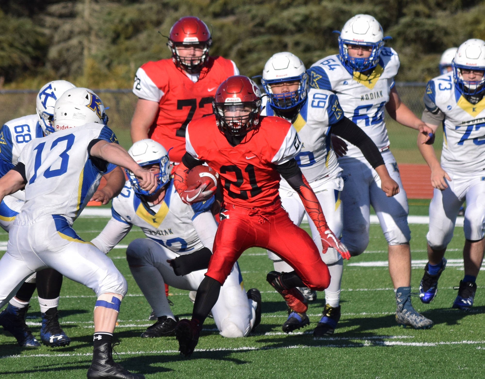 Kenai’s Zach Burnett (21) finds an opening in the defense Saturday afternoon against Kodiak at Kenai’s Ed Hollier Field. (Photo by Joey Klecka/Peninsula Clarion)