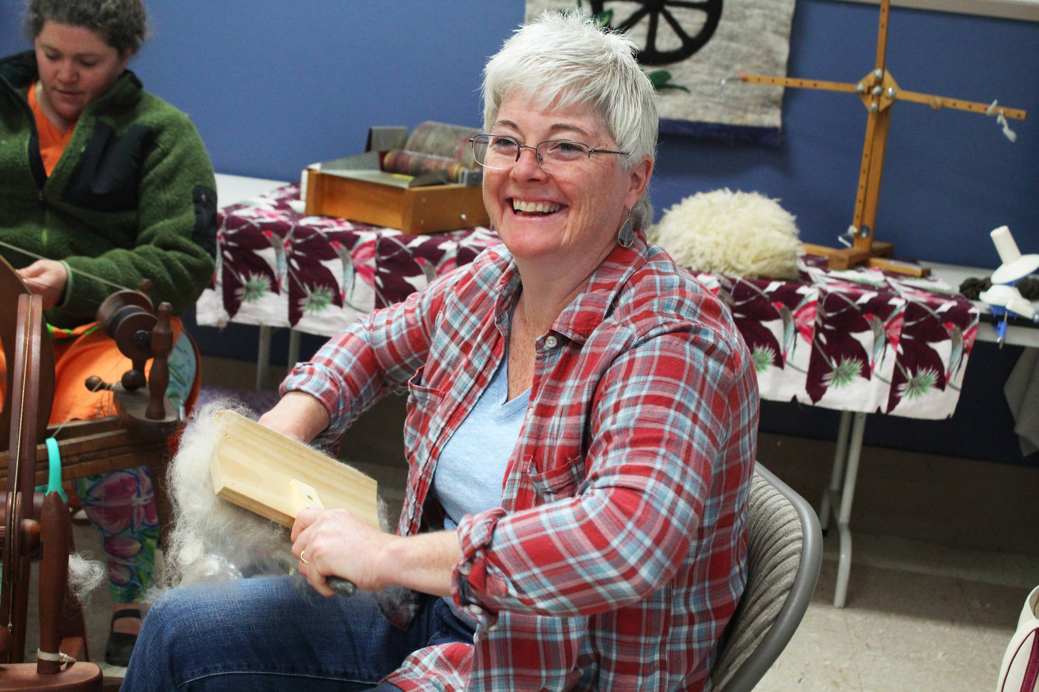 Karen Porter, a member of the Fireweed Fiber Guild, prepares some fibers while spinning yarn with other guild members Friday, Aug. 18, 2017 at the 2017 Kenai Peninsula Fair in Ninilchik, Alaska. The guild will host the Fireweed FiberFest on Saturday and Sunday, Sept. 29 and 30, 2018 at the Soldotna Sports Complex in Soldotna, Alaska. (Photo by Megan Pacer/Homer News)