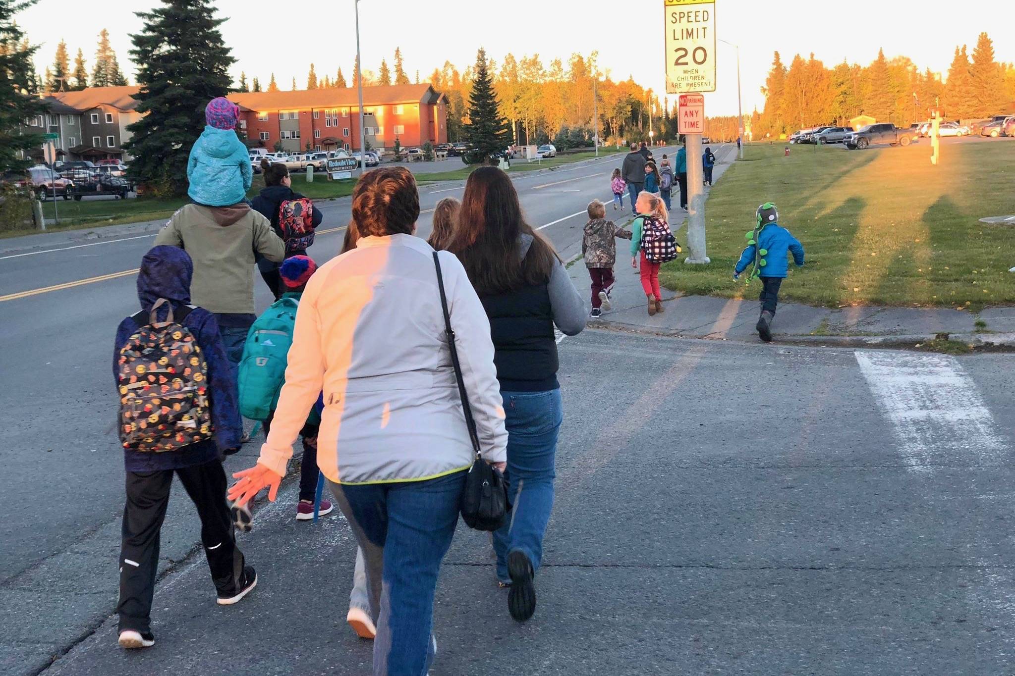Students and parents safely cross the street on their way to school for Walk to School Day, on Tuesday, Sept. 25, 2018, in Soldotna, Alaska. (Photo by Victoria Petersen/Peninsula Clarion)