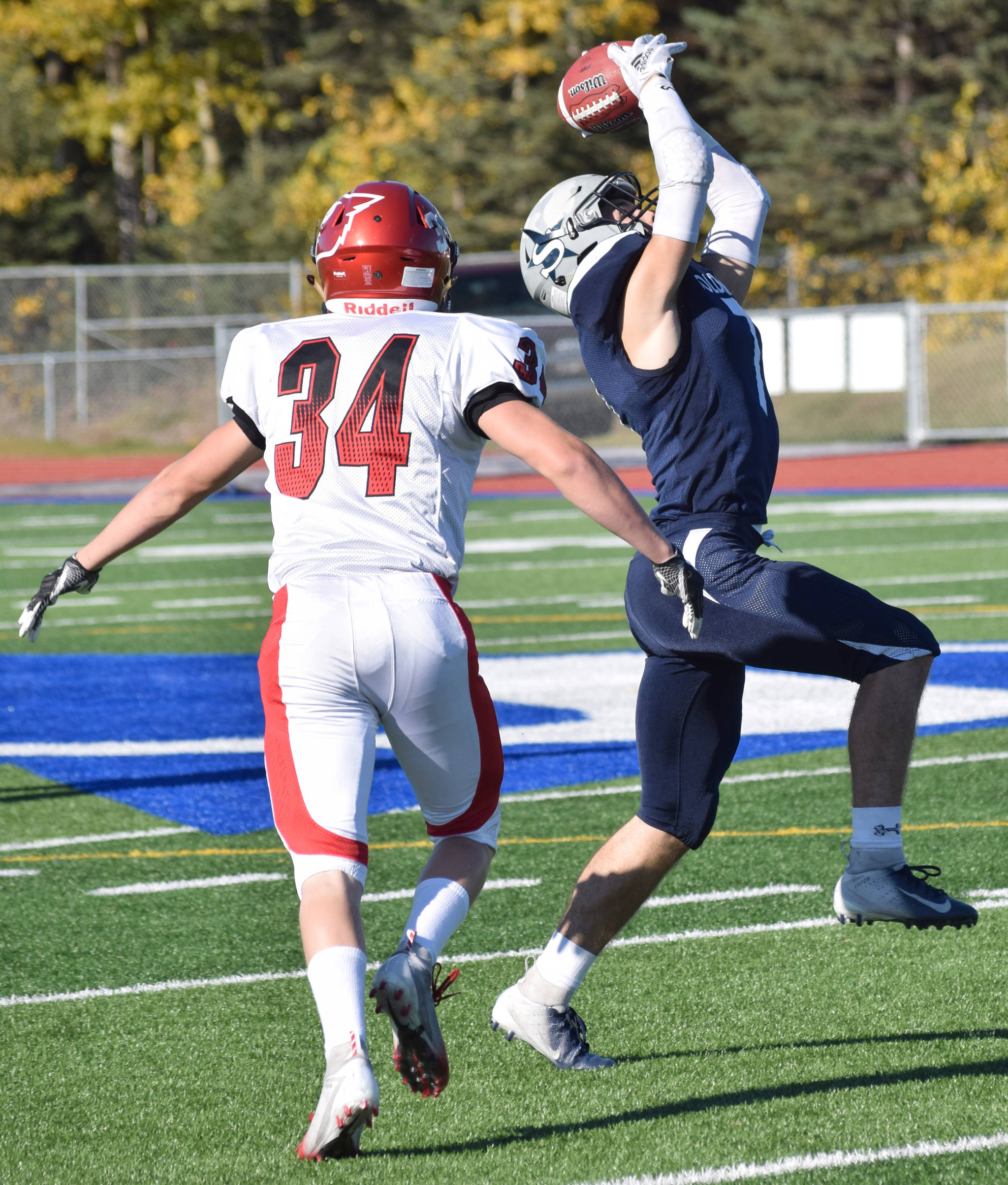 Soldotna’s Wyatt Medcoff picks off Kenai Central quarterback Connor Felchle in front of intended receiver Joey Sylvester on Saturday, Sept. 29, 2018, at Justin Maile Field in Soldotna. (Photo by Jeff Helminiak/Peninsula Clarion)