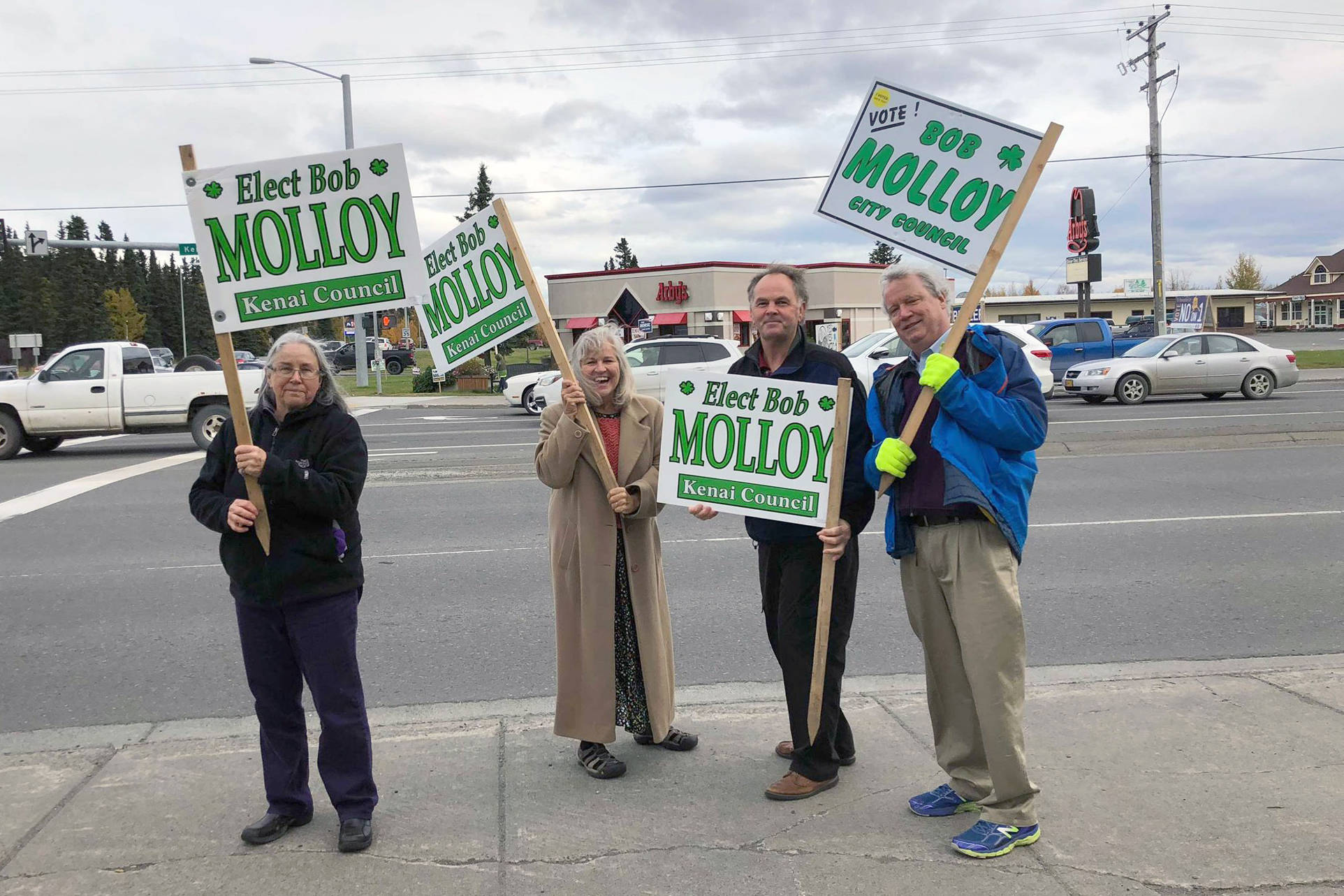 Supporters campaign for Kenai City Council member Bob Molloy on the corner of Main Street Loop and Kenai Spur Highway on Tuesday, Oct. 2, 2018 in Kenai, Alaska. (Photo by Victoria Petersen/Peninsula Clarion)