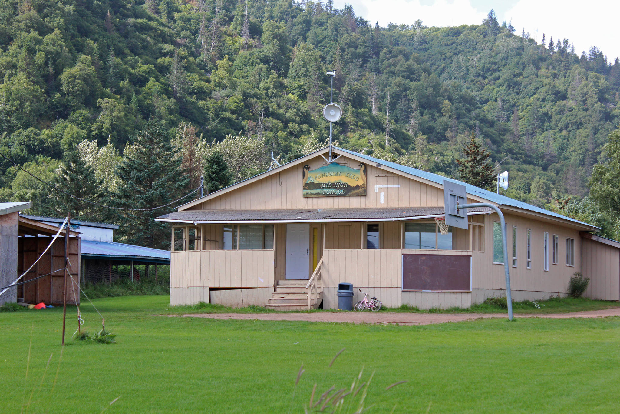 The Kachemak Selo Middle-High School building sits against a backdrop of the ridge separating the village from the Kenai Peninsula Borough road system Thursday, Aug. 30 in Kachemak Selo. (Photo by Megan Pacer/Homer News)