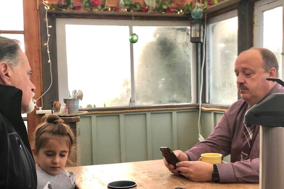 Sen. Peter Micciche and his daughter stopped by to talk with Sean Dusek at the Coffee with the Superintendant event on Friday morning, Oct. 5, at Veronica’s Cafe in Kenai, Alaska. (Photo by Victoria Petersen/Peninsula Clarion)