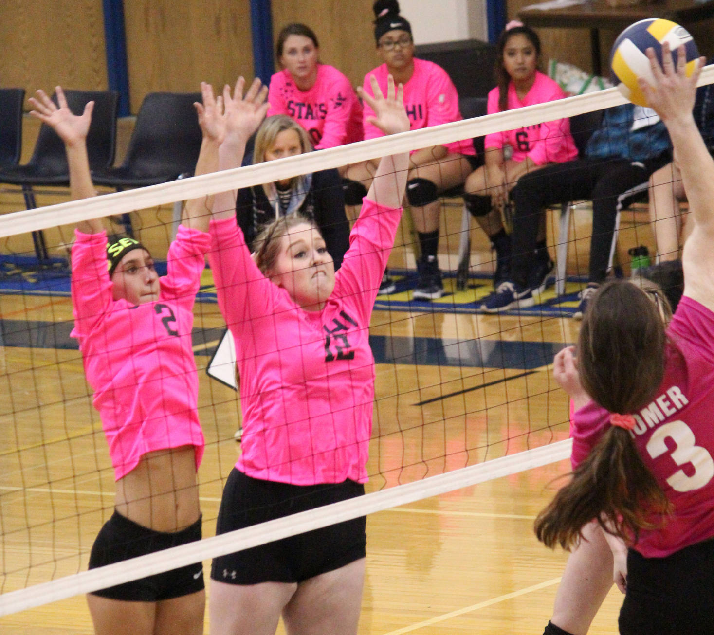 Soldotna High School’s Carsen Brown (left) and Bailey Leach (right) jump to block a spike from Homer’s Tonda Smude during their game Tuesday, Oct. 9, 2018 at the Alice Witte Gymnasium in Homer, Alaska. (Photo by Megan Pacer/Homer News)
