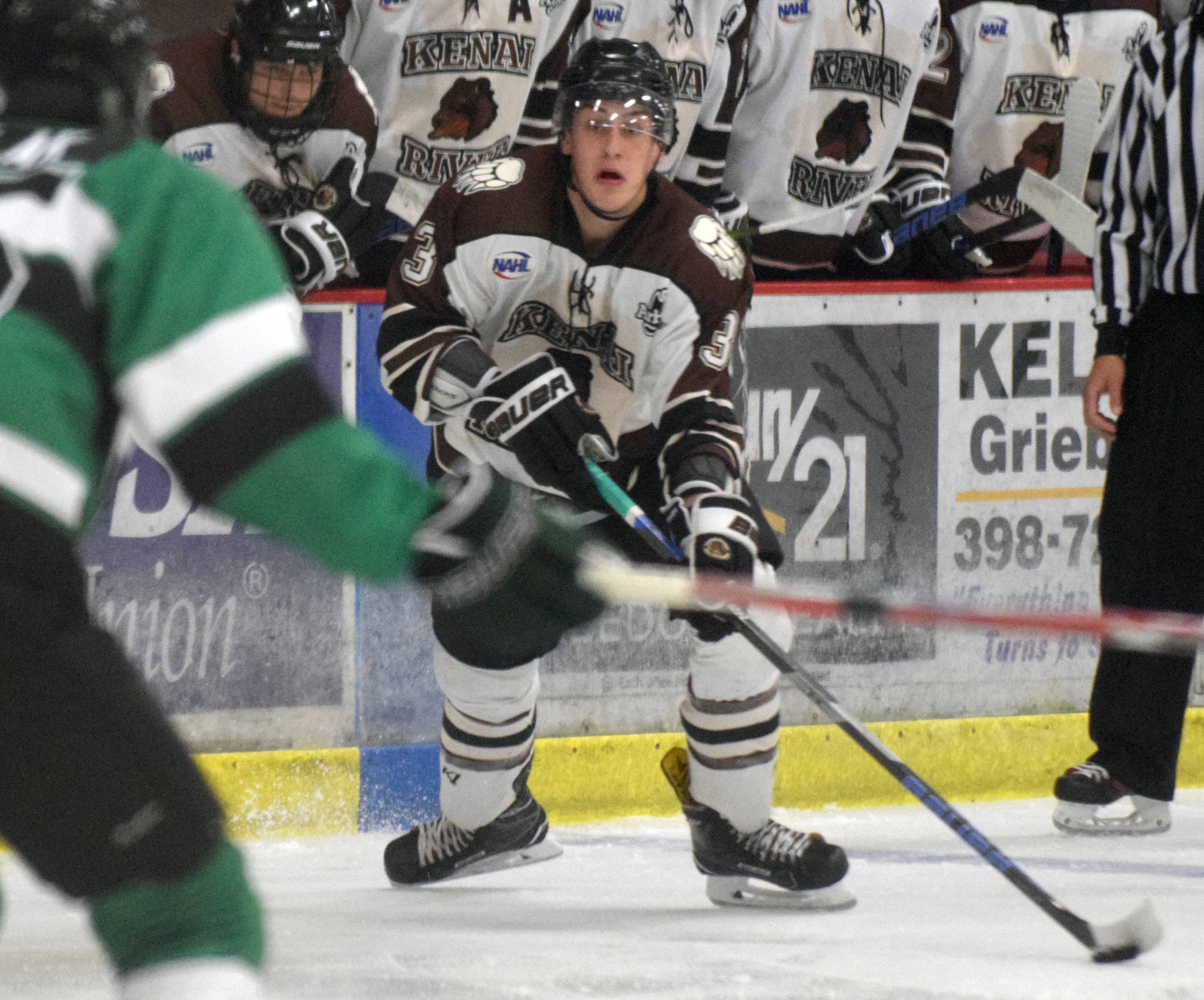 Kenai River Brown Bears defenseman JJ Boucher looks for an opening Friday, Oct. 5, 2018, against the Chippewa (Wisconsin) Steel at the Soldotna Regional Sports Complex. (Photo by Jeff Helminiak/Peninsula Clarion)