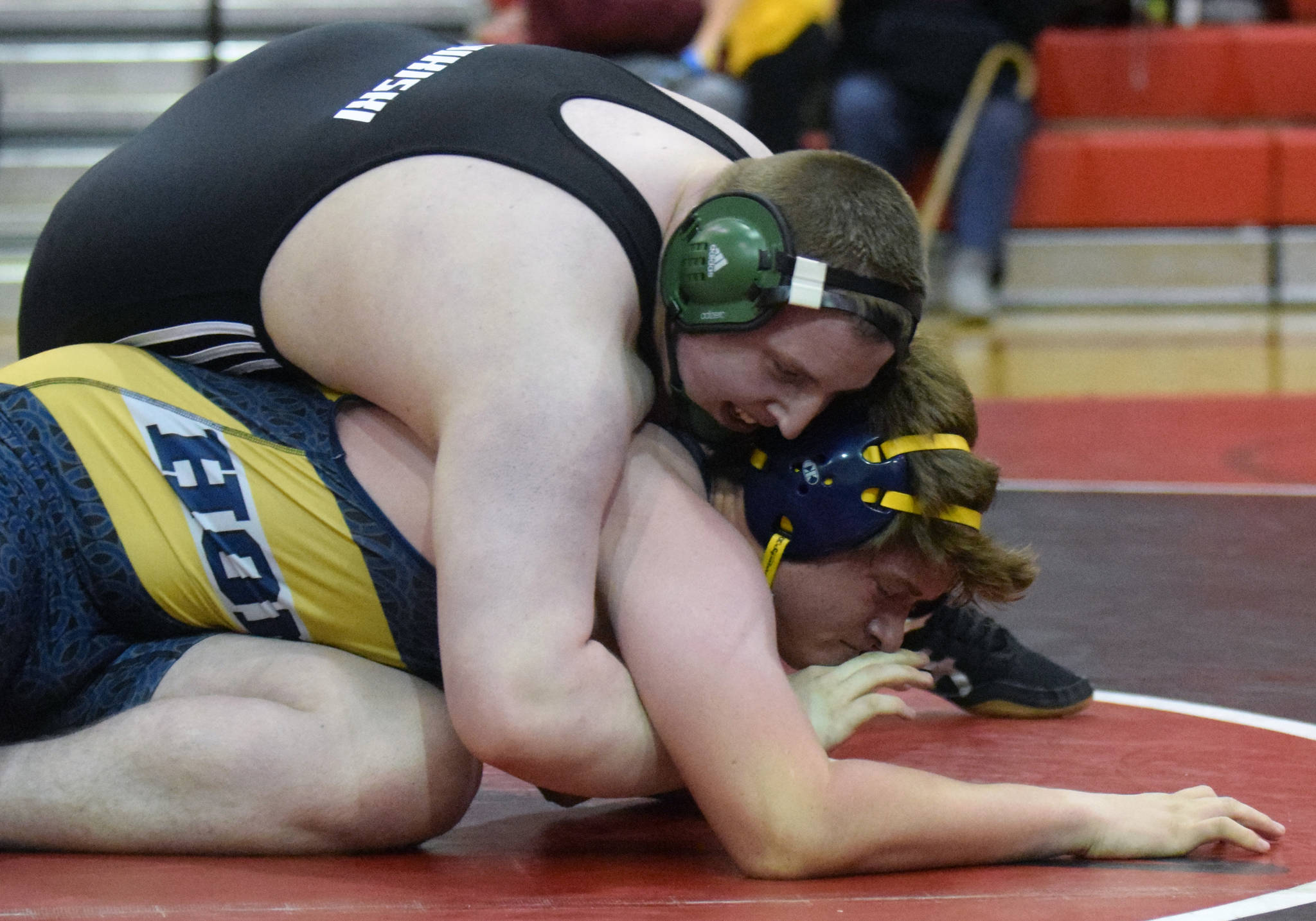 Nikiski’s Ethan Hack controls Homer’s Hunter Harrington in the third-place match at 285 pounds Saturday, Oct. 13, 2018, at the Luke Spruill Memorial Tournament at Kenai Central High School. Harrington would win the match by pin. (Photo by Jeff Helminiak/Peninsula Clarion)