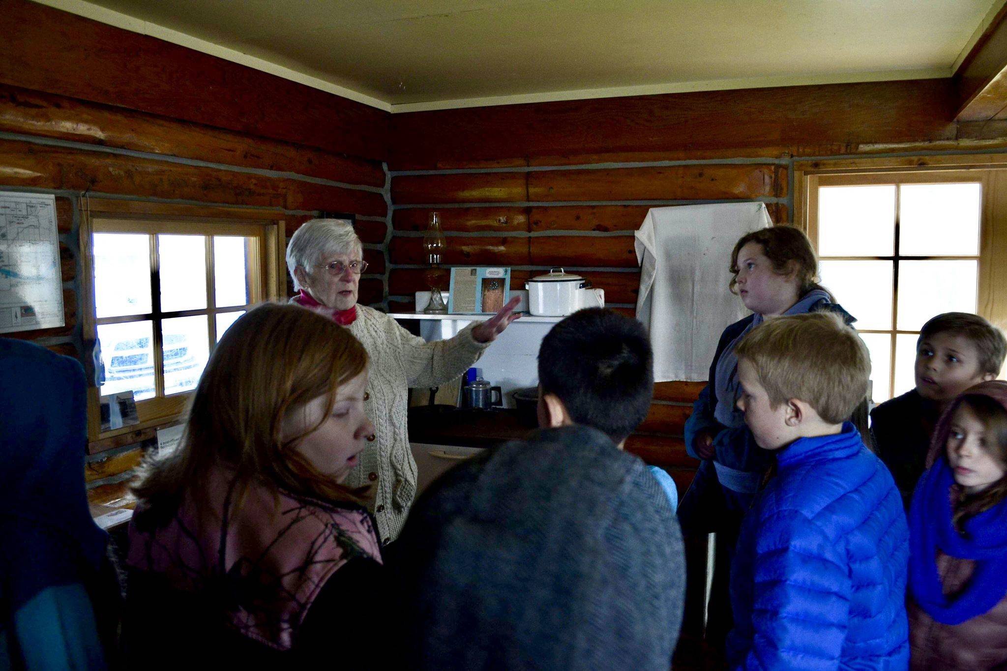 Marge Mullen shows a group of third graders around the Howard Lee Homestead, which was used as the city’s first post office when she first homesteaded in Soldotna, on Wednesday, Oct. 17, 2018, in Soldotna, AK. (Photo by Victoria Petersen/Peninsula Clarion)