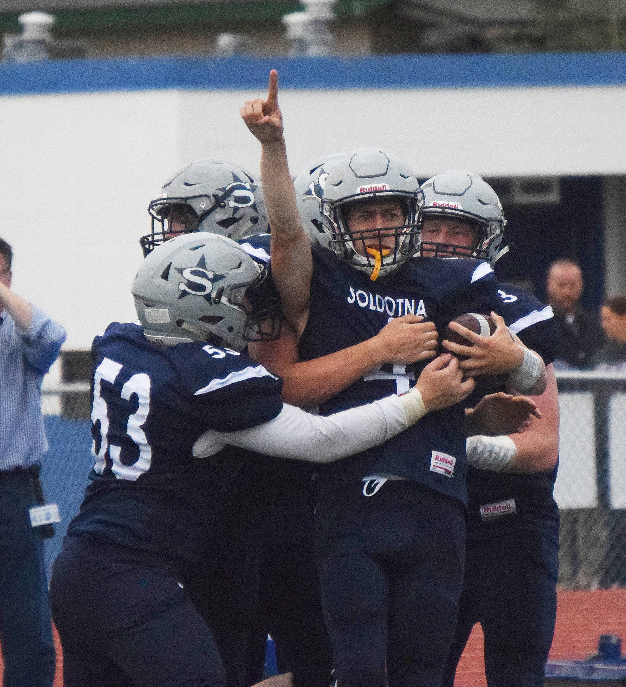 Soldotna junior Jersey Truesdell (pointing) is mobbed by teammates after scoring a touchdown Aug. 10, 2018, against West Anchorage at Justin Maile Field in Soldotna. (Photo by Joey Klecka/Peninsula Clarion)