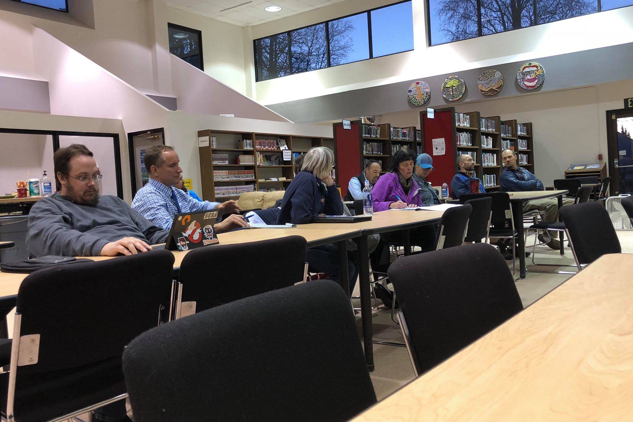 Parents, teachers, staff and concerned public gather at the Kenai Central High School library to listen to Superintendent Sean Dusek and Assistant Superintendent Dave Jones discuss the future Kenai Peninsula Borough School District budget on Tuesday in Kenai. (Photo by Victoria Petersen/Peninsula Clarion)