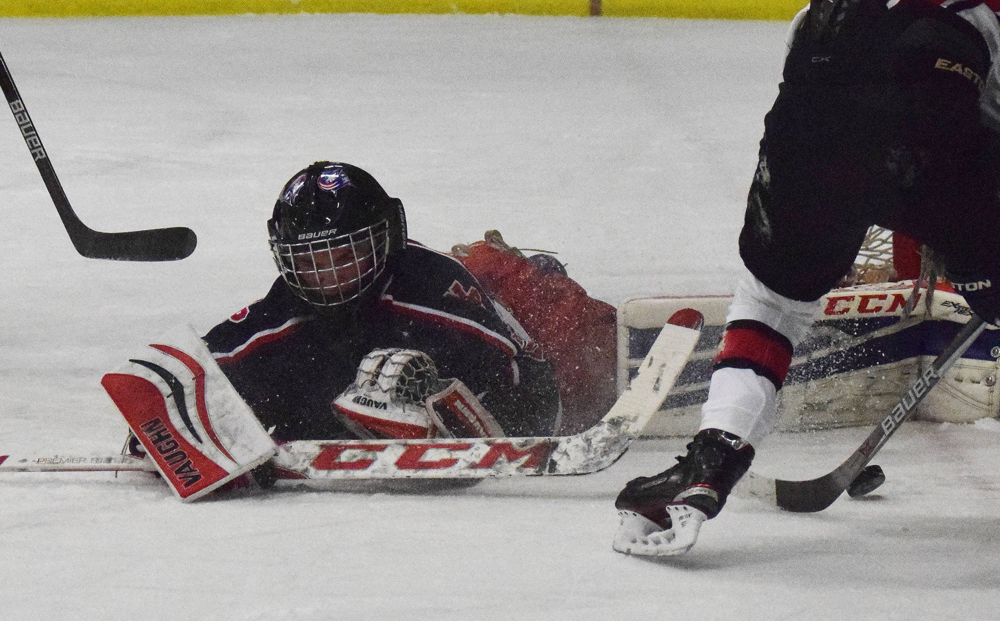 North Pole goalie Moses Halbert spreads out to make a save Thursday night against Kenai Central at the Peninsula Ice Challenge at the Kenai Multi-purpose Facility. (Photo by Joey Klecka/Peninsula Clarion)