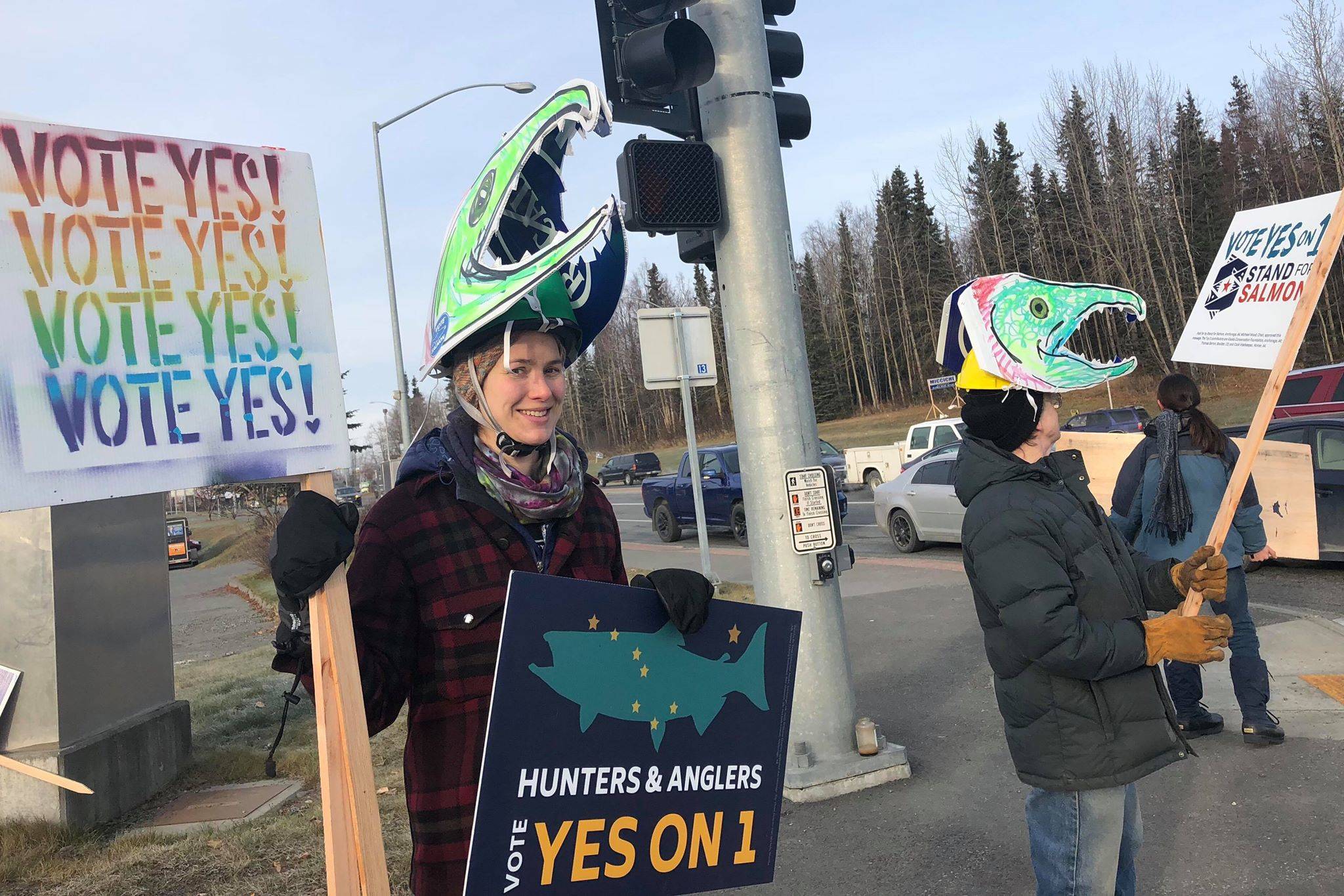 Supporters of the “Stand for Salmon” Ballot Measure 1 hold signs at the intersection of the Sterling and Kenai Spur Highways on Tuesday, Nov. 6, 2018, in Soldotna, Alaska. (Photo by Victoria Petersen/Peninsula Clarion)