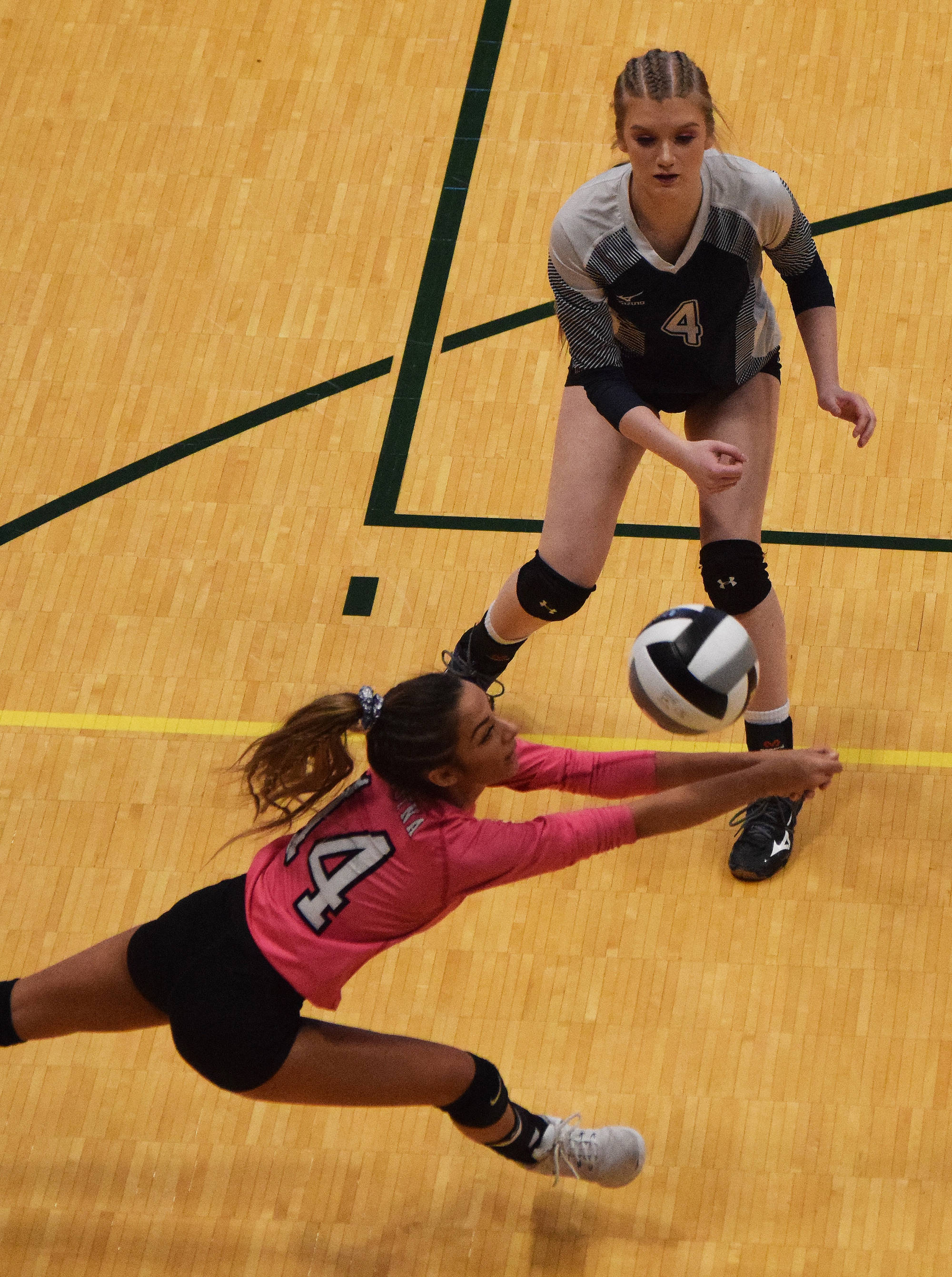 Soldotna’s Holleigh Jaime dives for a ball with teammate Kodi McGillivray (4) watching Friday afternoon against Colony at the Class 4A state volleyball tournament at the Alaska Airlines Center. (Photo by Joey Klecka/Peninsula Clarion)