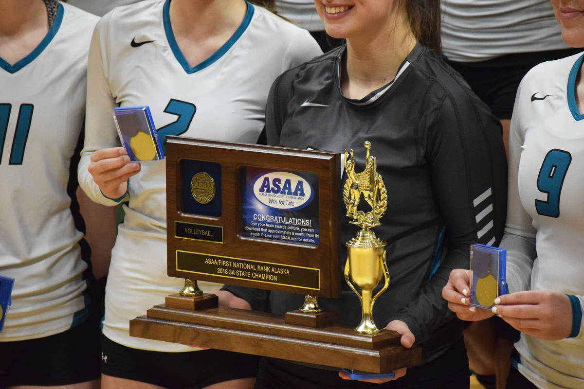 The Nikiski Bulldogs display the championship trophy Saturday after the Class 3A state volleyball final against Valdez at the Alaska Airlines Center. (Photo by Joey Klecka/Peninsula Clarion)