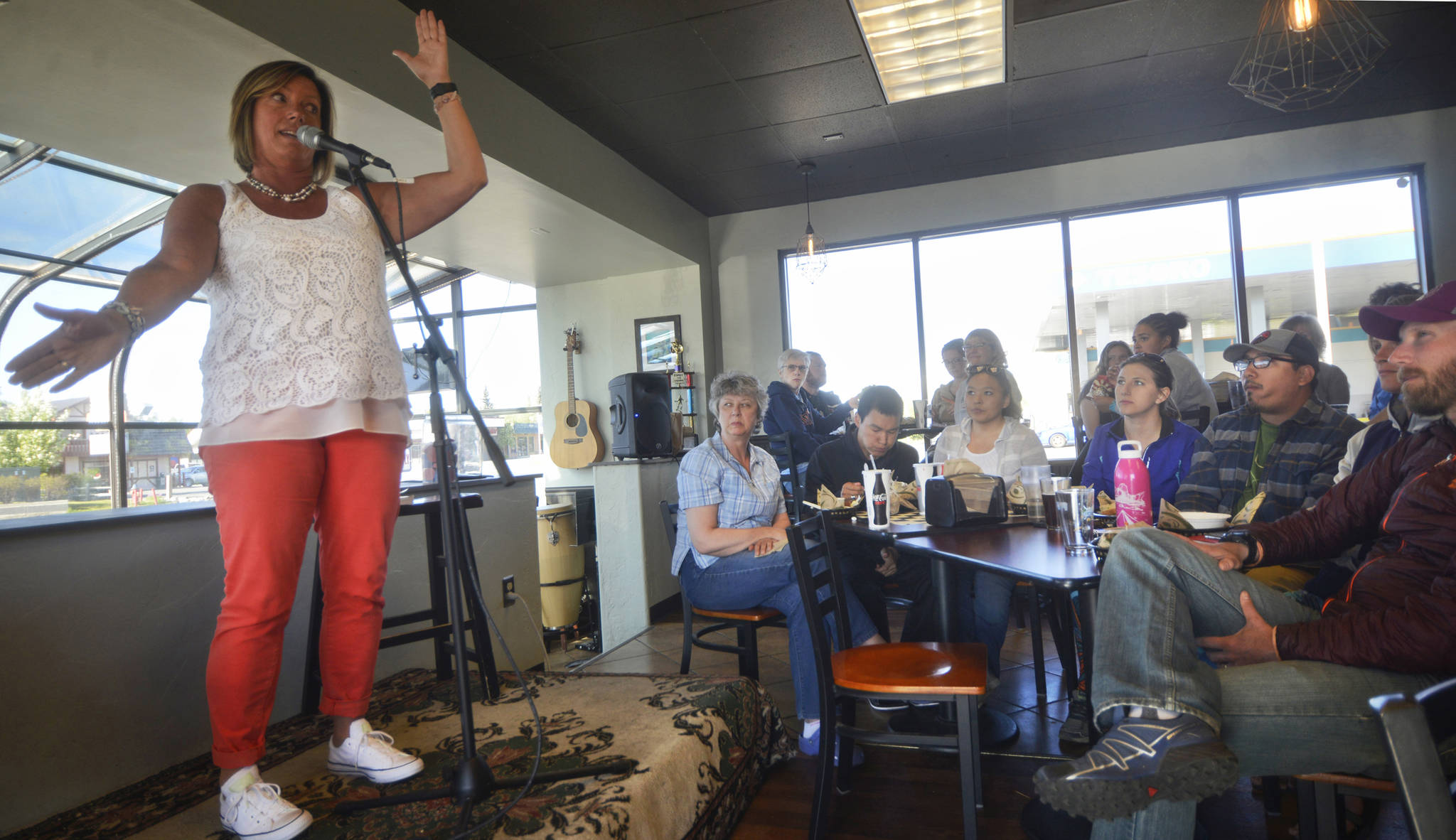 Pegge Erkeneff describes the fall of a tree while telling the story of an orphaned moose to listeners at Odie’s Deli on Friday, June 2, 2017 in Soldotna, Alaska. The seven storytellers who spoke that evening were participating in the latest session of True Tales Told Live, an ocassional storytelling evening cofounded by Erkeneff, Jenny Nyman, and Kaitlin Vadla. (Ben Boettger/Peninsula Clarion)