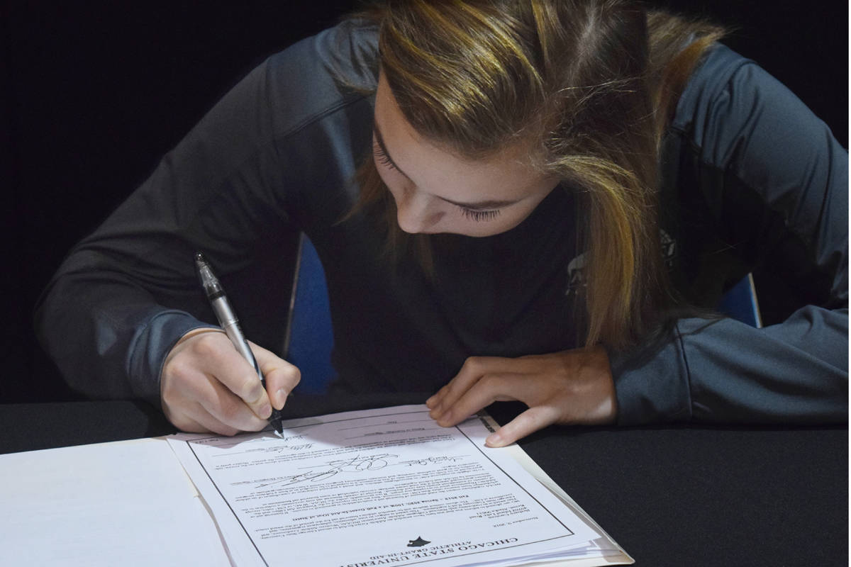 Nikiski senior Bethany Carstens signs her letter of intent to play at Division I basketball at Chicago State University in a ceremony Thursday at Nikiski High School. (Photo by Joey Klecka/Peninsula Clarion)